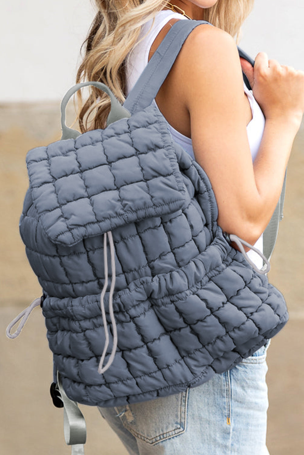 Black solid flapped quilted puffer backpack with spacious interior and modern design
