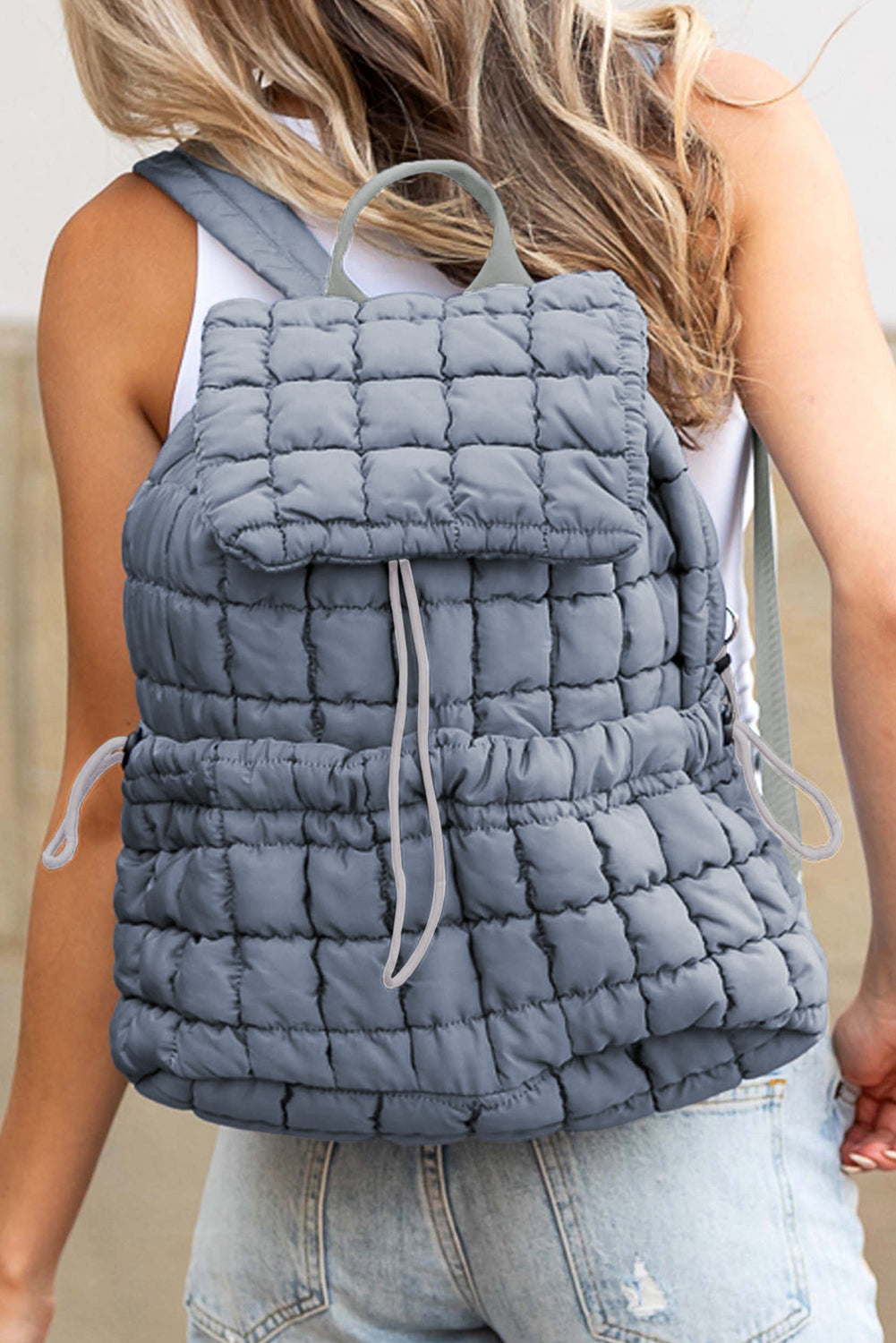 Black solid flapped quilted puffer backpack with spacious interior and modern design