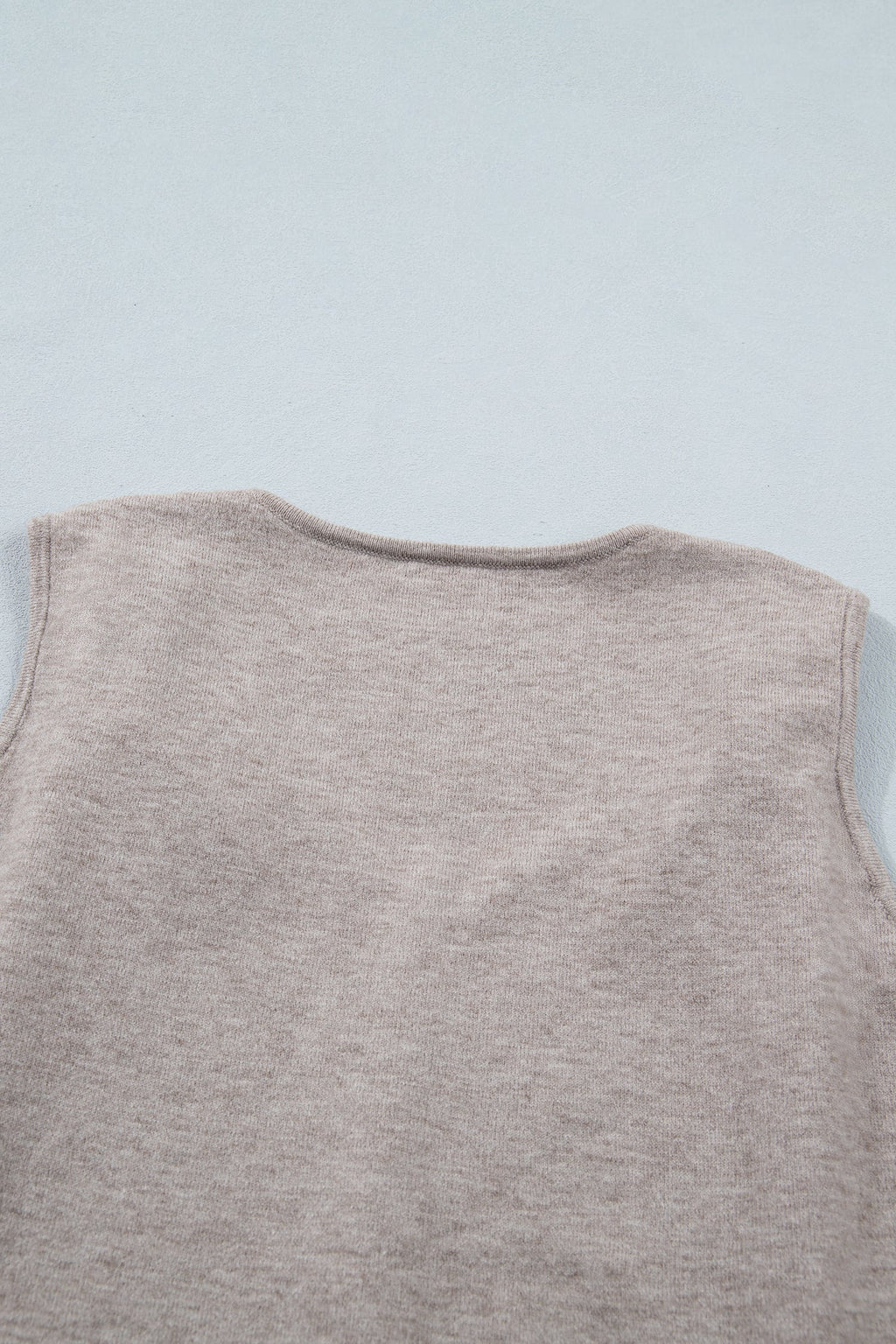 Gray sleeveless knit tank top with metallic star detail and V-neck design
