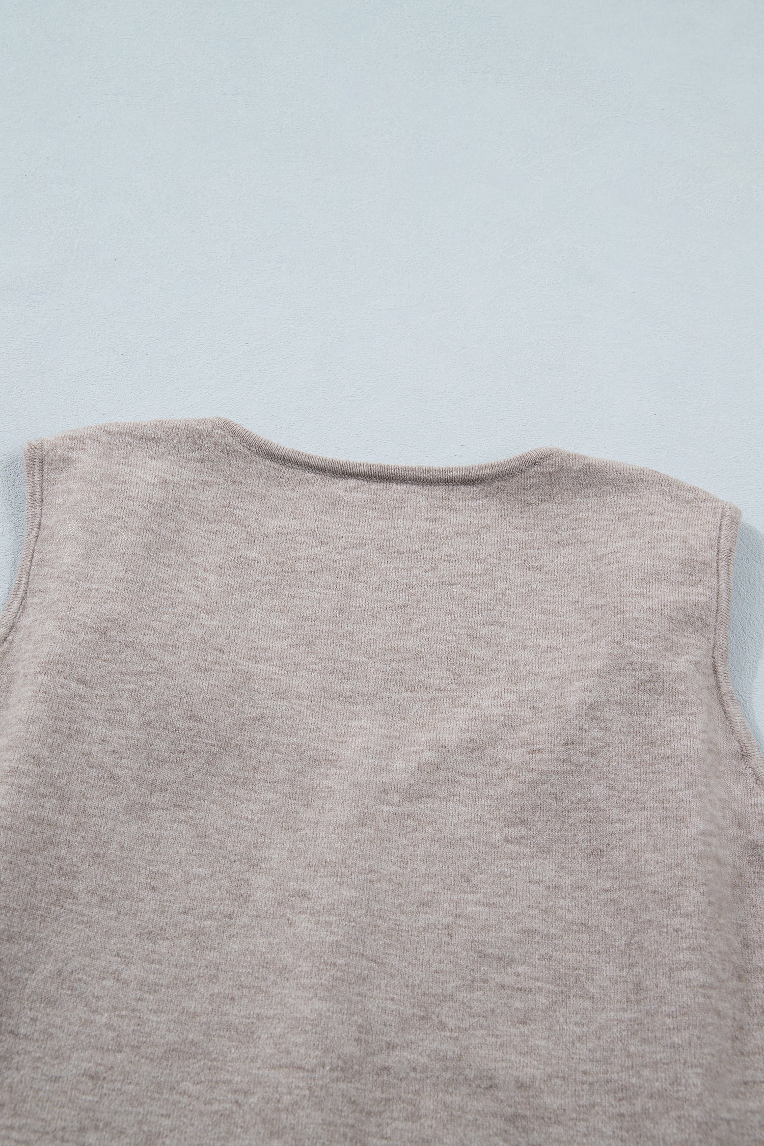 Gray sleeveless knit tank top with metallic star detail and V-neck design