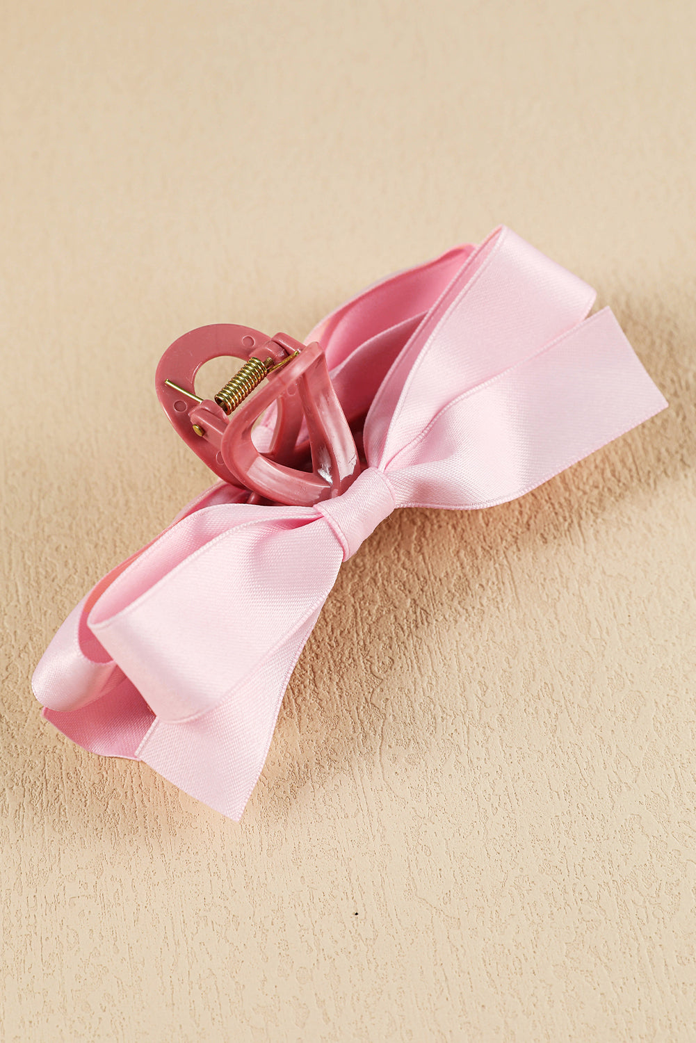 Large black hair claw clip with stylish bow decor for securing all hair types