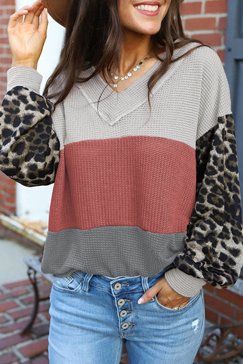 Red waffle knit top with wild leopard contrast sleeves and V-neck design