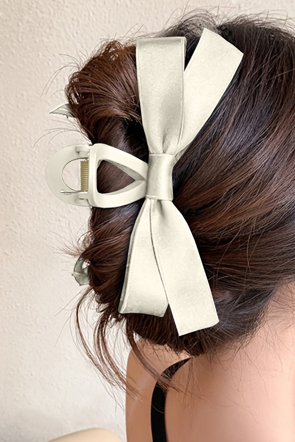 Large black bow decor hair claw clip securing hairstyle elegantly