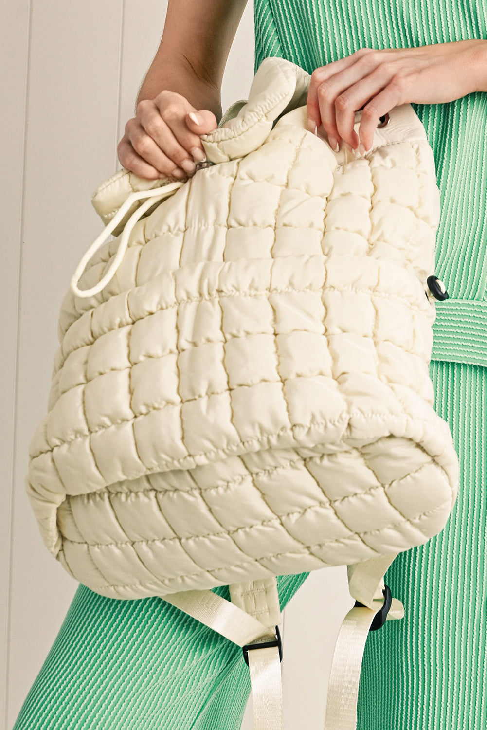 Black solid flapped quilted puffer backpack with spacious interior and textured design