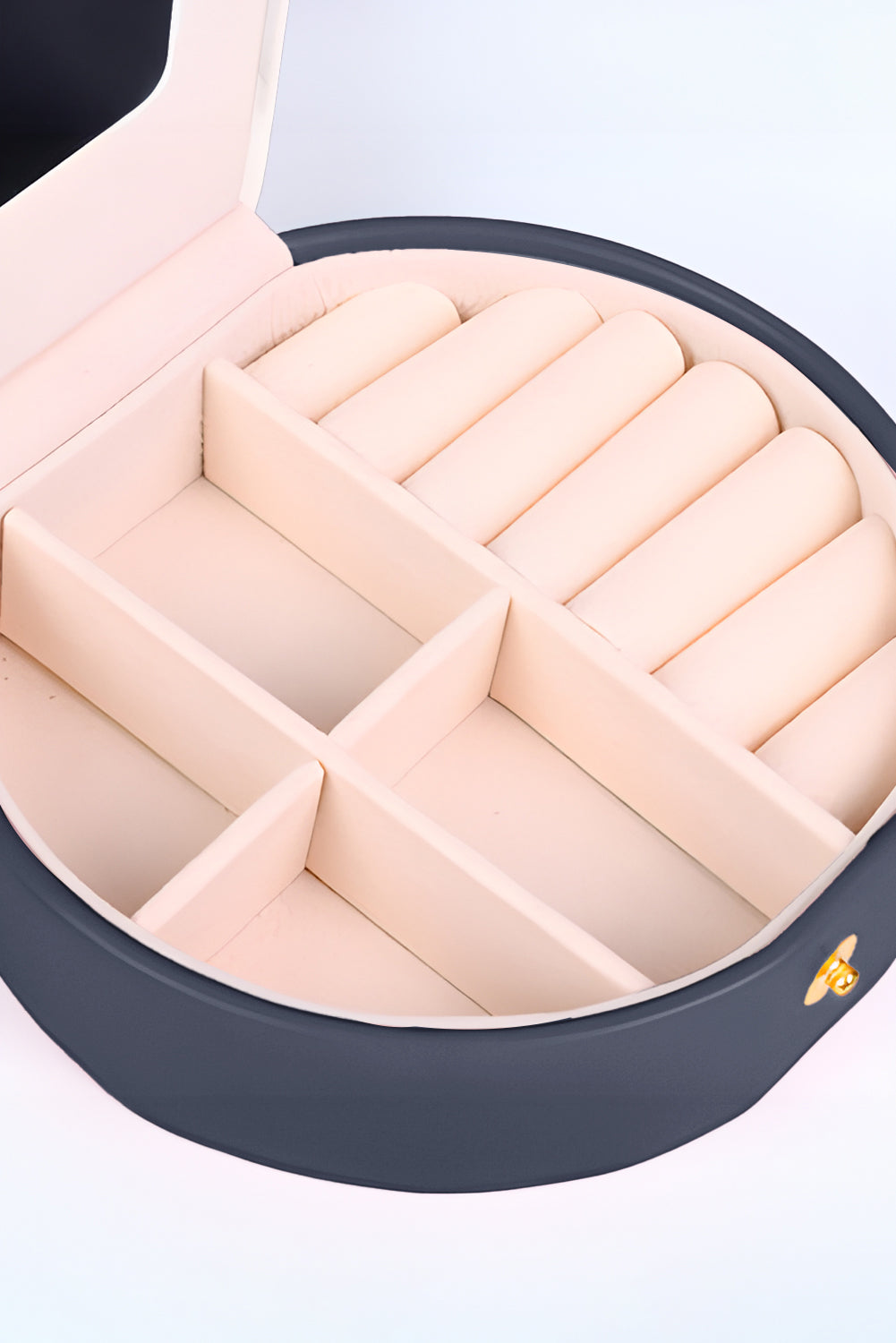 Light pink jewelry organizer cases with snap button closure and built-in mirror in compact round shape