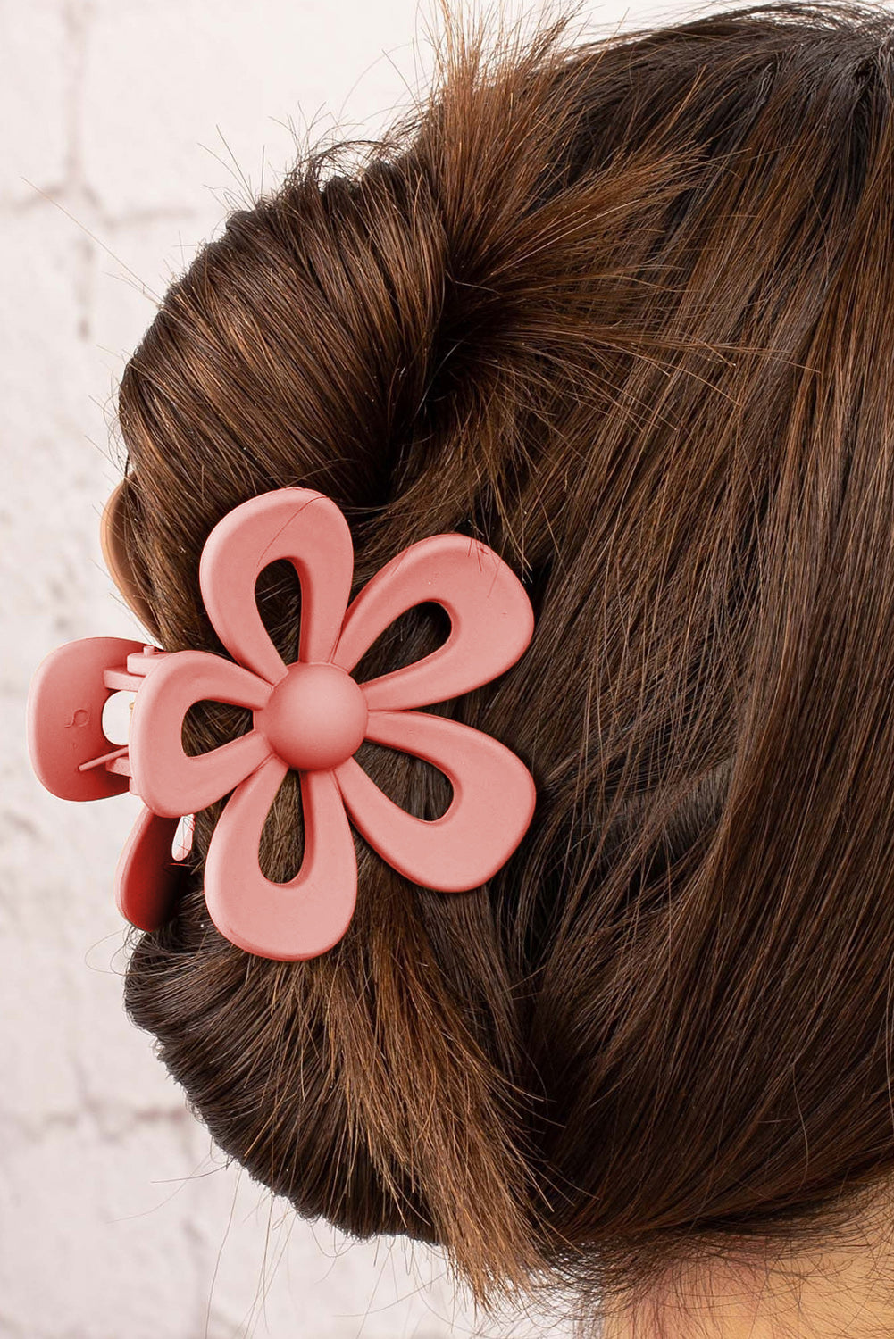 Black sweet hollowed flower shaped claw clip with frosting finish and durable plastic design