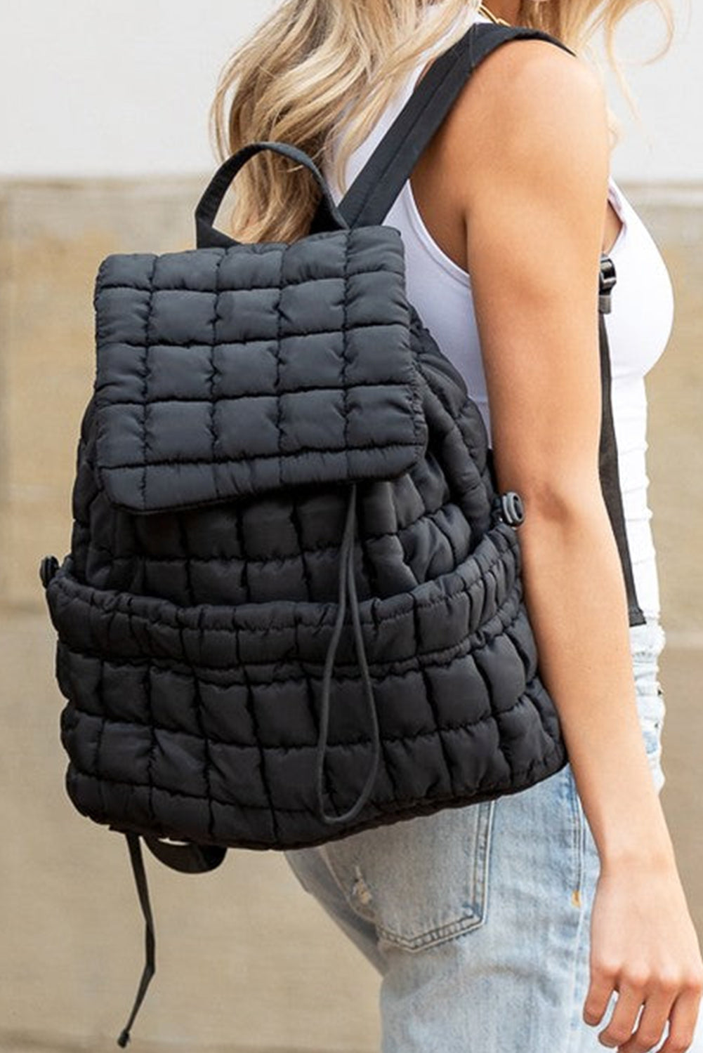 Black solid flapped quilted puffer backpack with spacious interior and stylish modern design