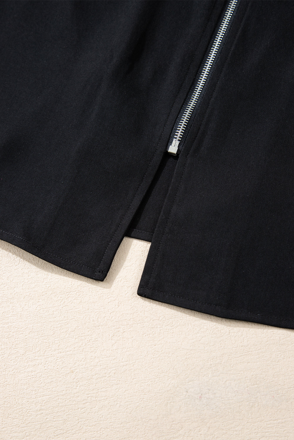 Black collar jacket with tab sleeves and zip-up flap detail