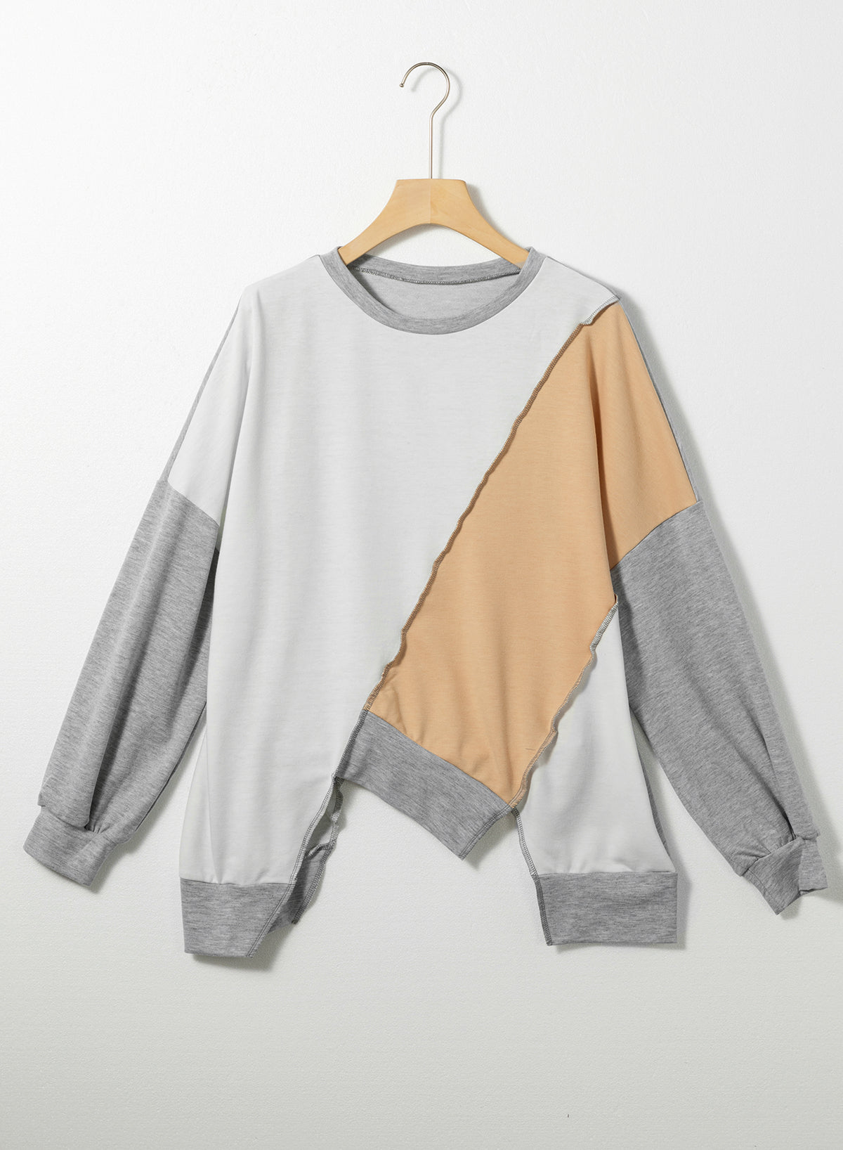 Light French Beige colorblock long sleeve top with irregular hem and stitching details