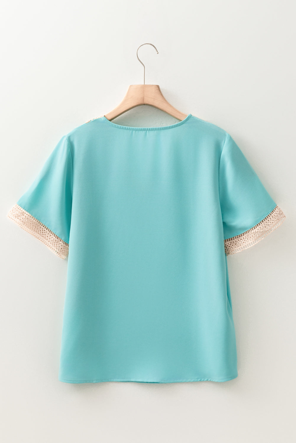 Green V neck blouse with delicate lace trim and short sleeves