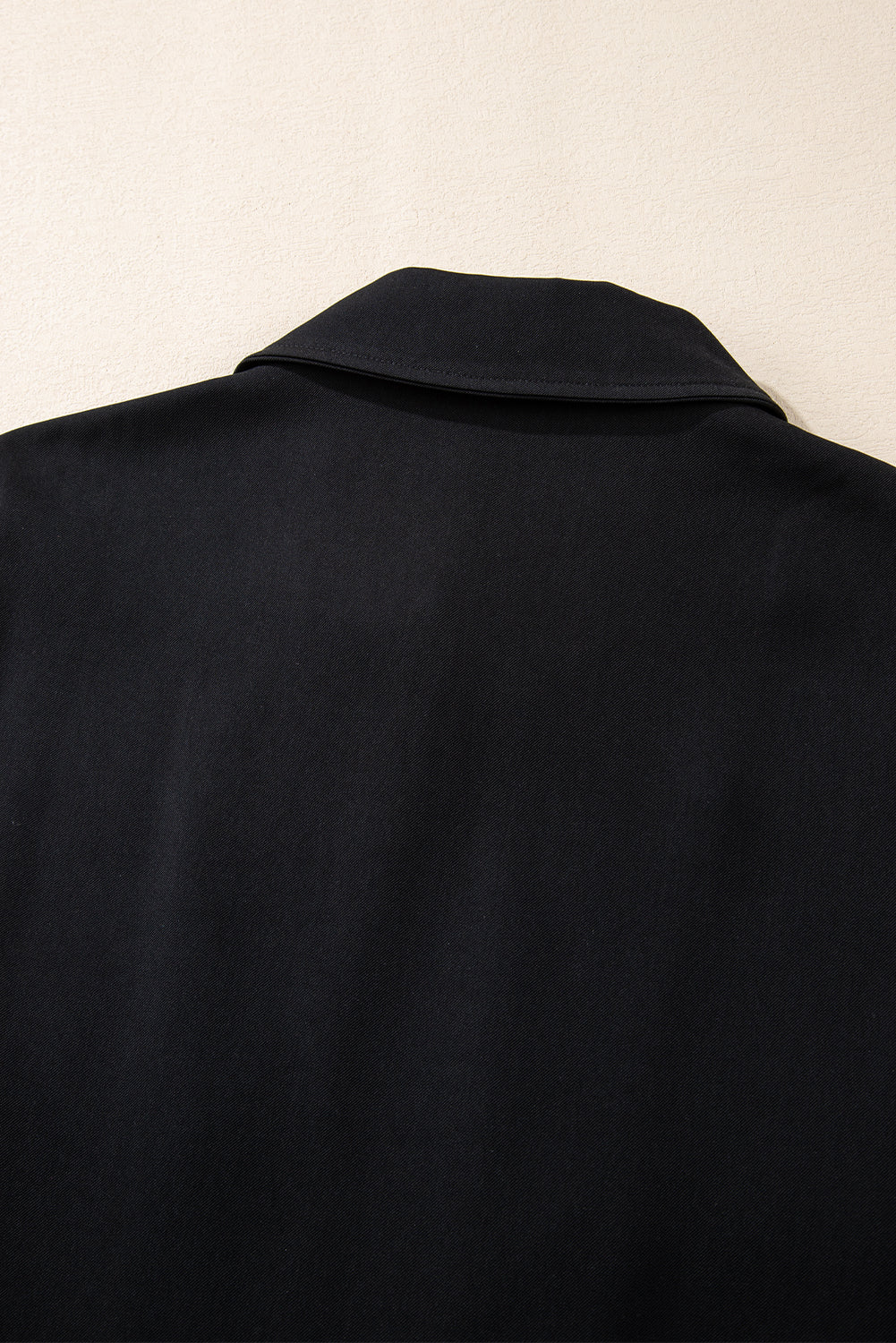 Black collar jacket with tab sleeves and zip-up flap detail