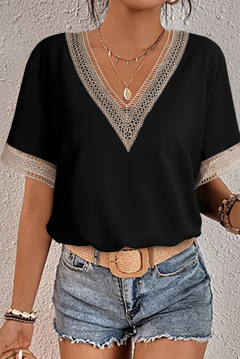 Green V-neck blouse with delicate green lace trim and short sleeves