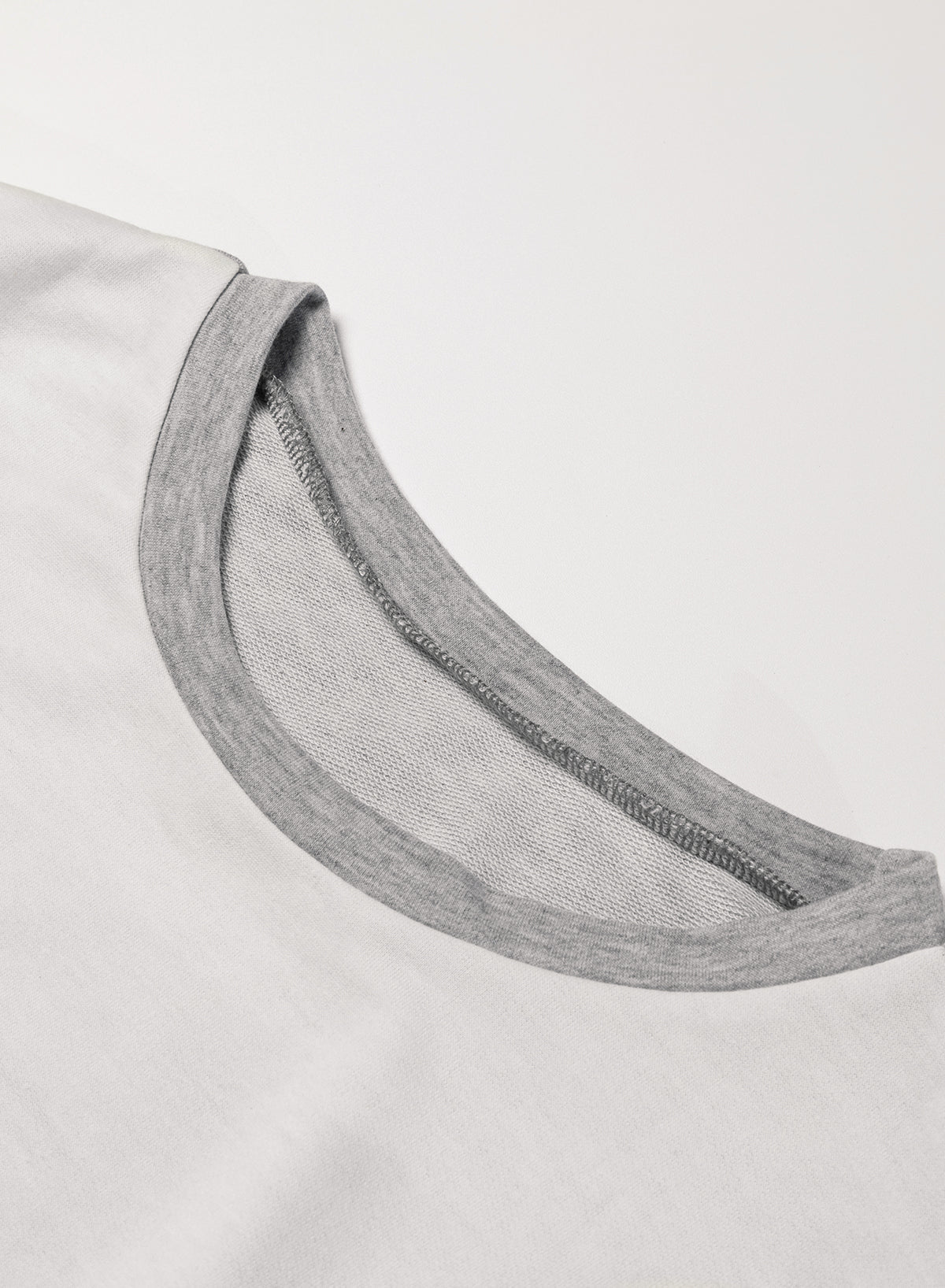 Light French Beige colorblock long sleeve top with irregular hem and patchwork design