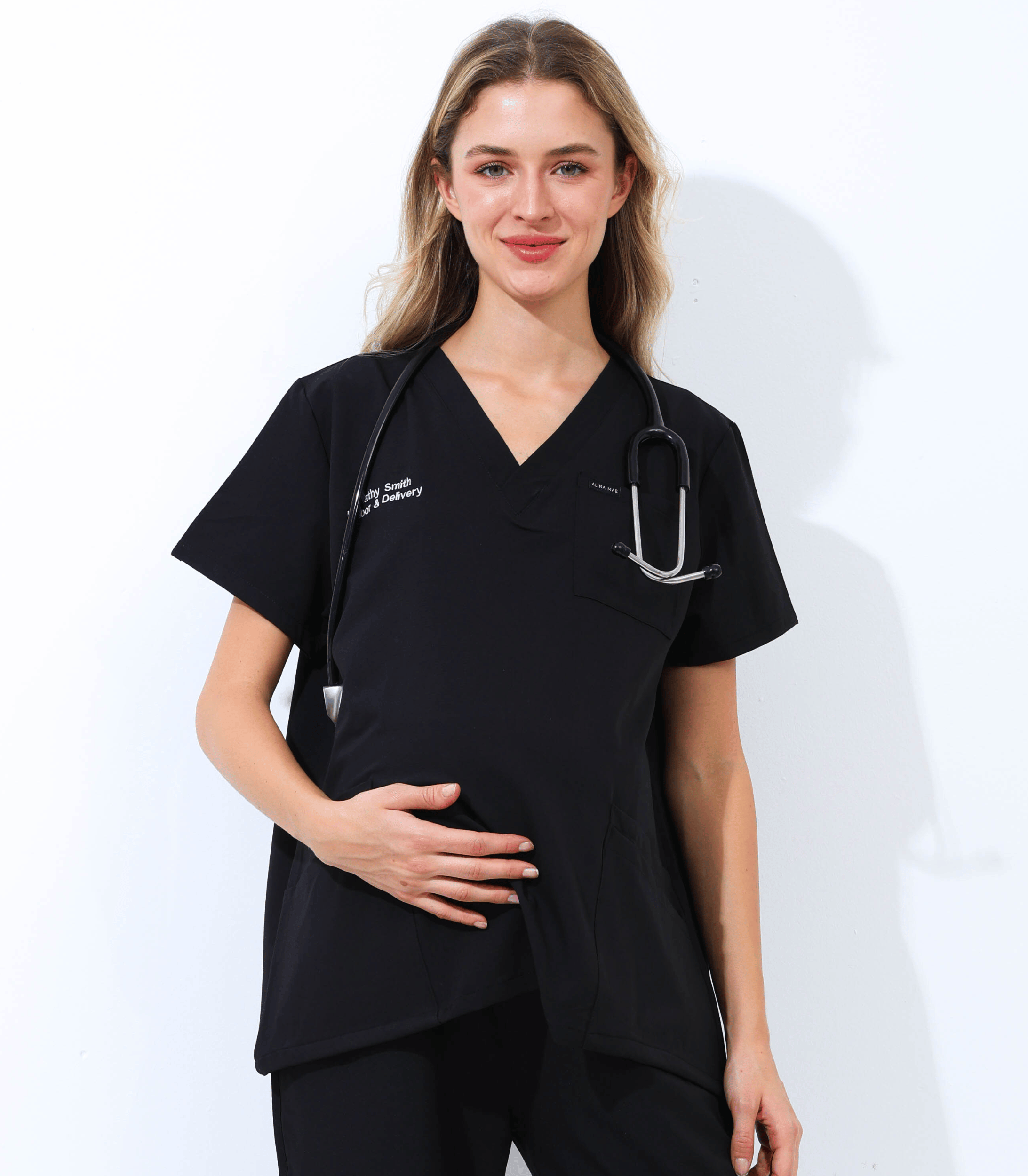 Pregnant medical professional wearing Mae maternity scrub top from Maternity Scrubs Collection