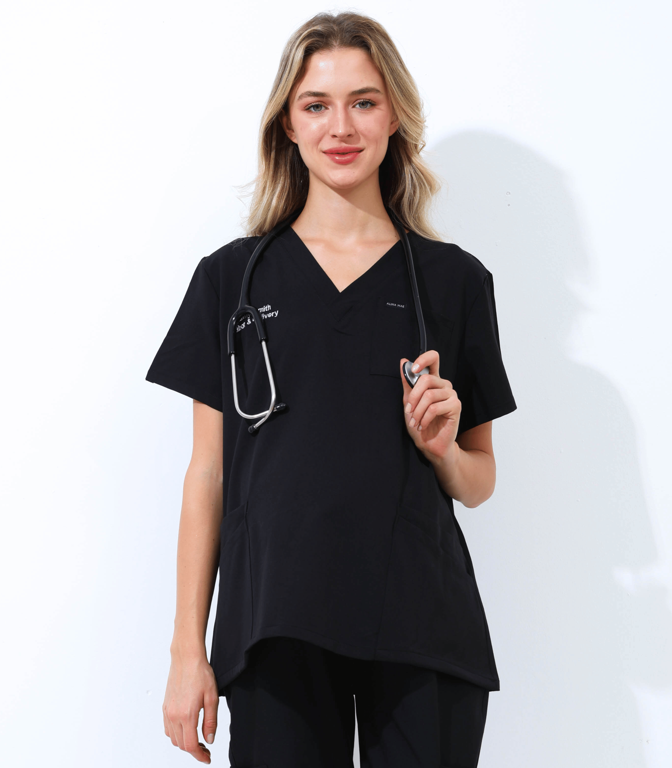 Pregnant medical professional wearing stylish and comfortable maternity scrubs from the Maternity Scrubs Collection designed for healthcare workers.