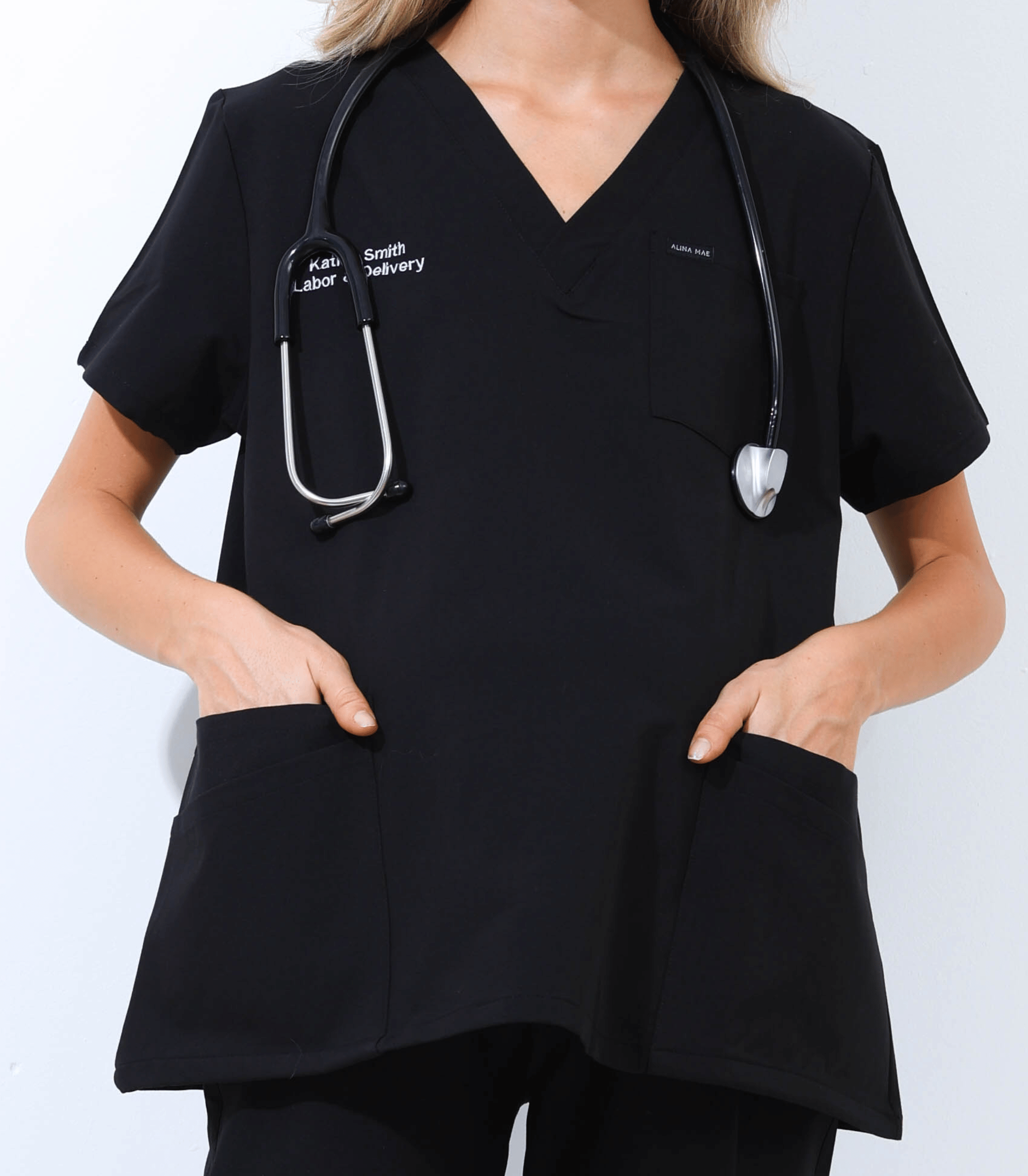 Pregnant medical professional wearing stylish and comfortable maternity scrubs from the Maternity Scrubs Collection