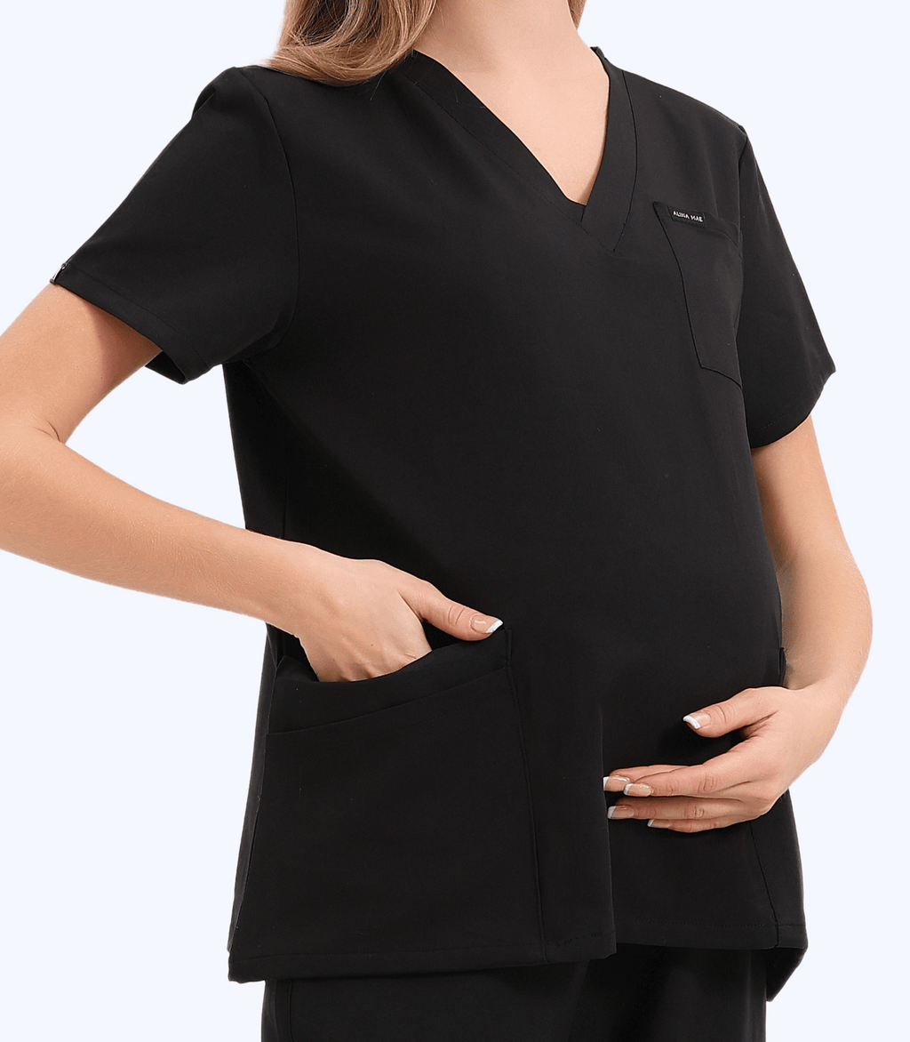 Pregnant medical professional wearing stylish Mae maternity scrub top from Maternity Scrubs Collection