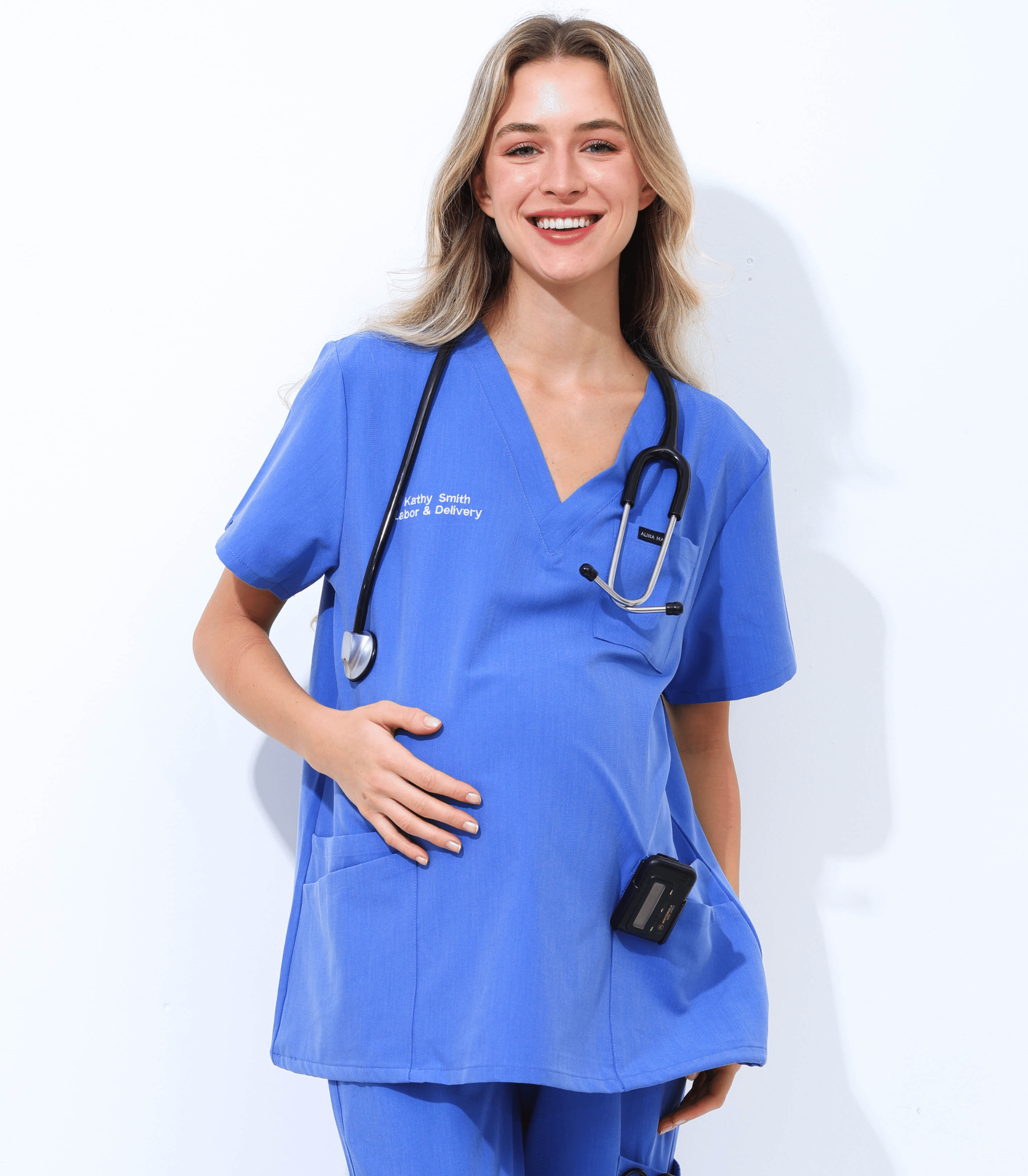 Pregnant woman wearing stylish and comfortable maternity scrubs from the Maternity Scrubs Collection designed for medical professionals.