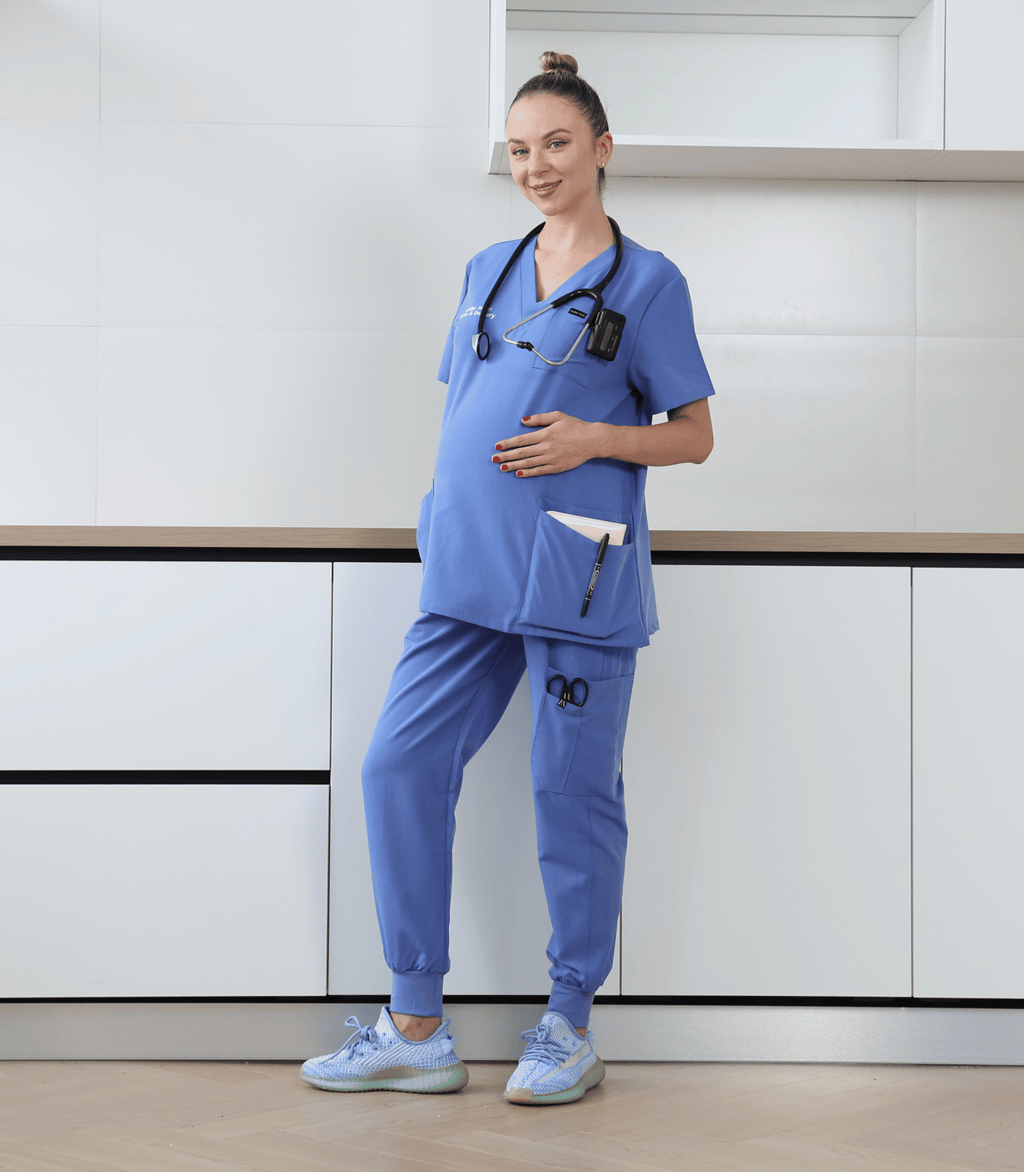 Pregnant medical professional wearing stylish and comfortable maternity scrubs from the Maternity Scrubs Collection designed for healthcare workers
