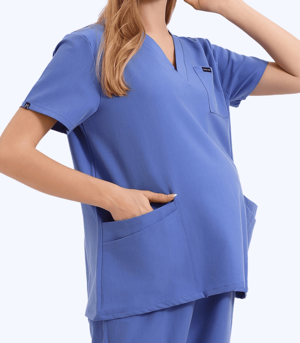 Woman wearing Mae maternity scrub top from Maternity Scrubs Collection designed for comfort and functionality during pregnancy