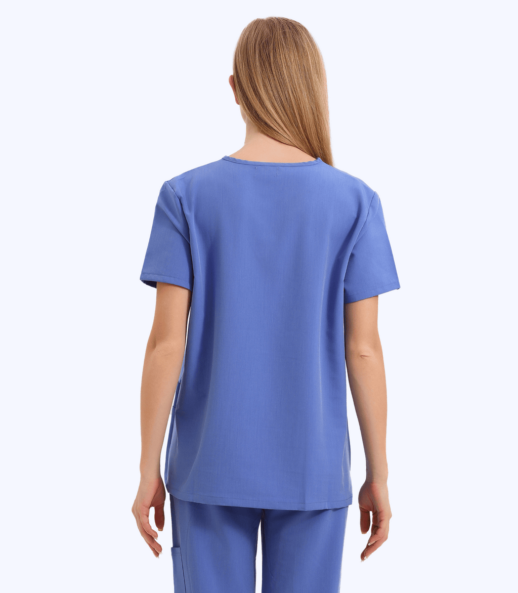 Pregnant medical professional wearing pink maternity scrub top from Maternity Scrubs Collection