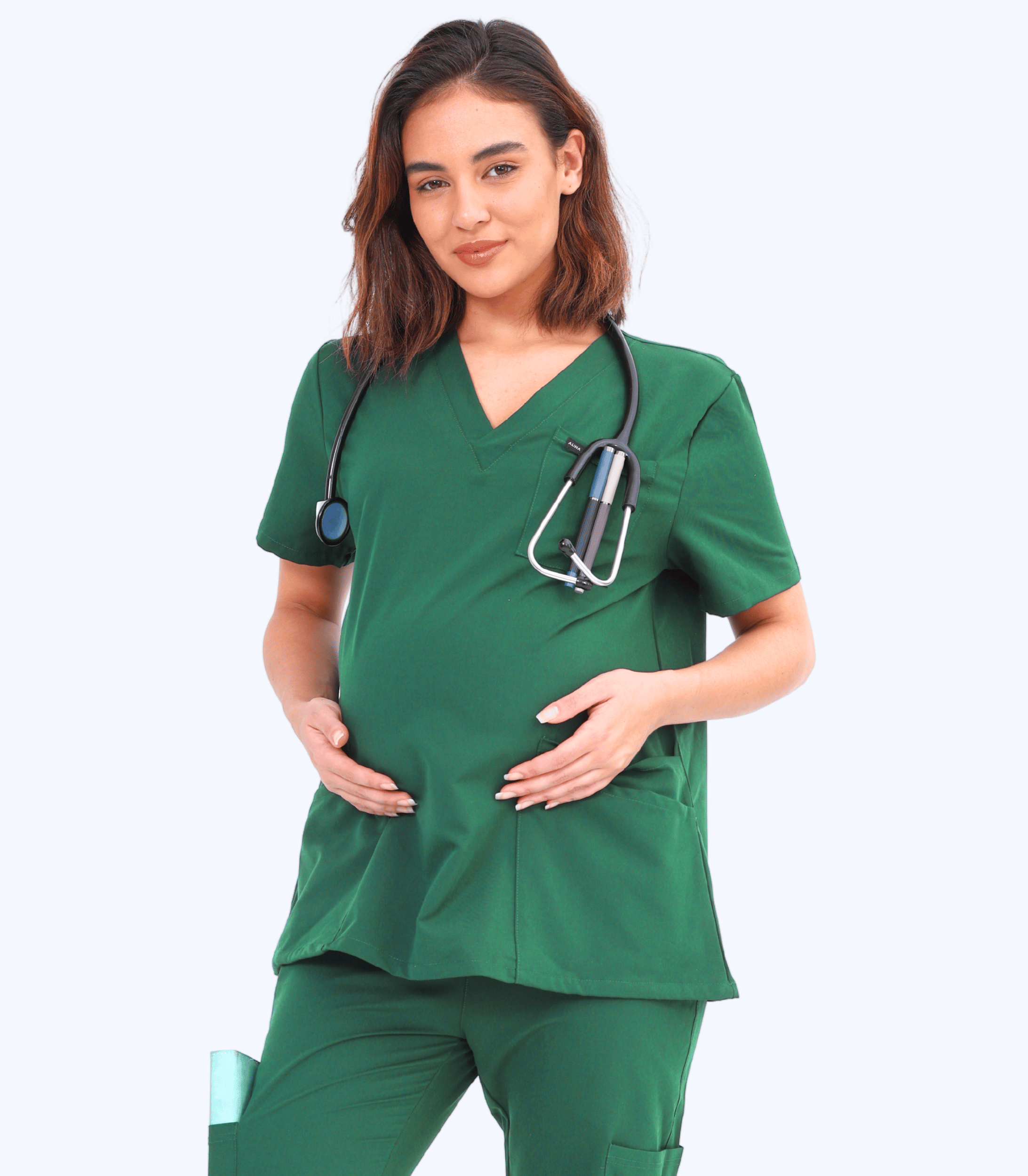 Pregnant woman wearing a comfortable and stylish maternity scrub top from the Maternity Scrubs Collection designed for healthcare professionals