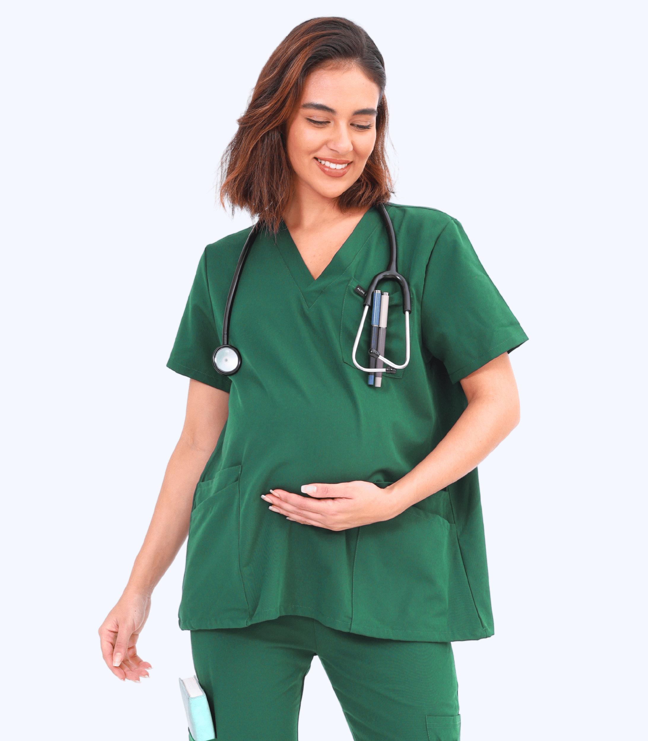 Pregnant woman wearing stylish and comfortable maternity scrubs from the Maternity Scrubs Collection designed for medical professionals.