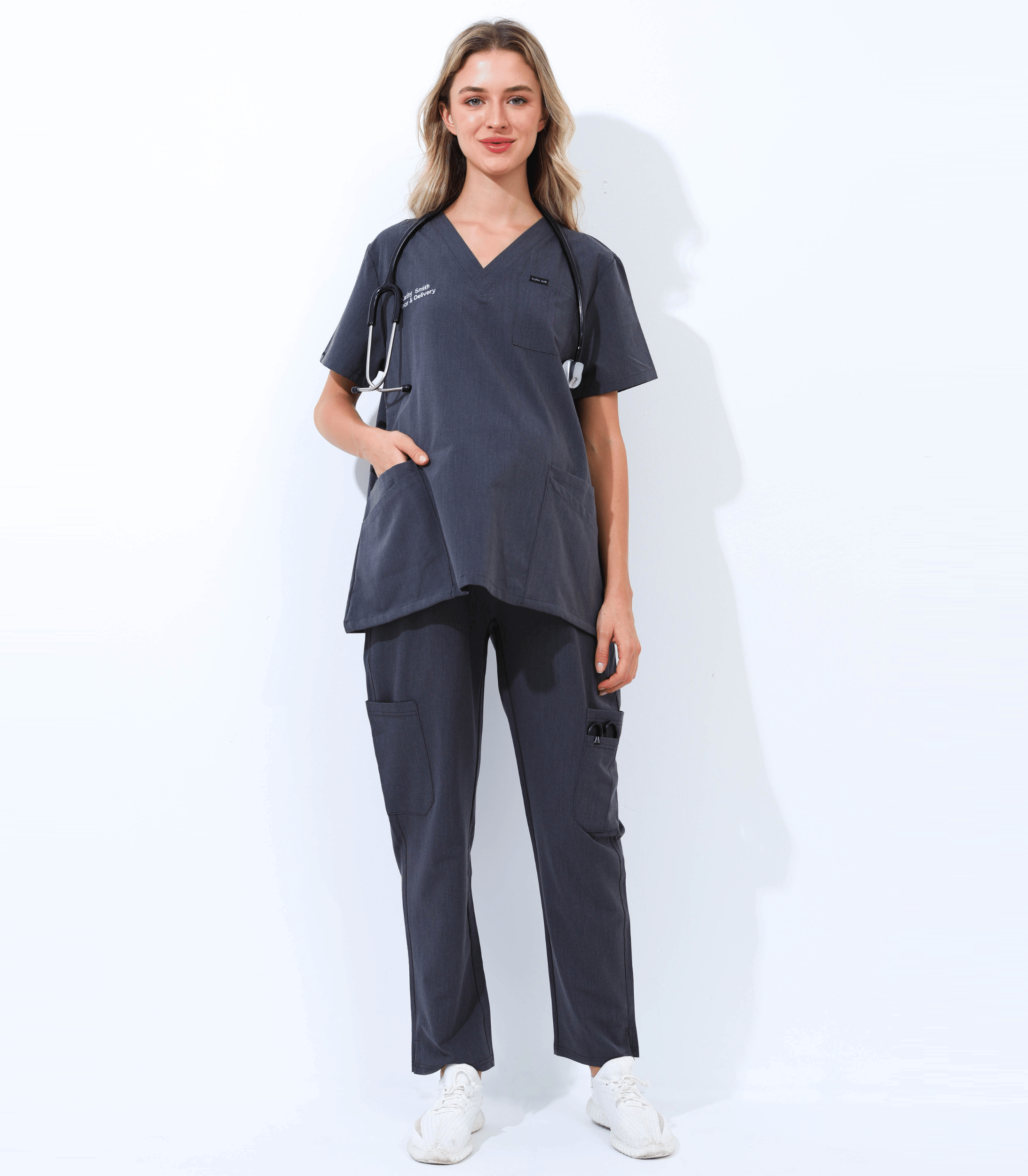 Pregnant medical professional wearing stylish and comfortable maternity scrubs from the Maternity Scrubs Collection