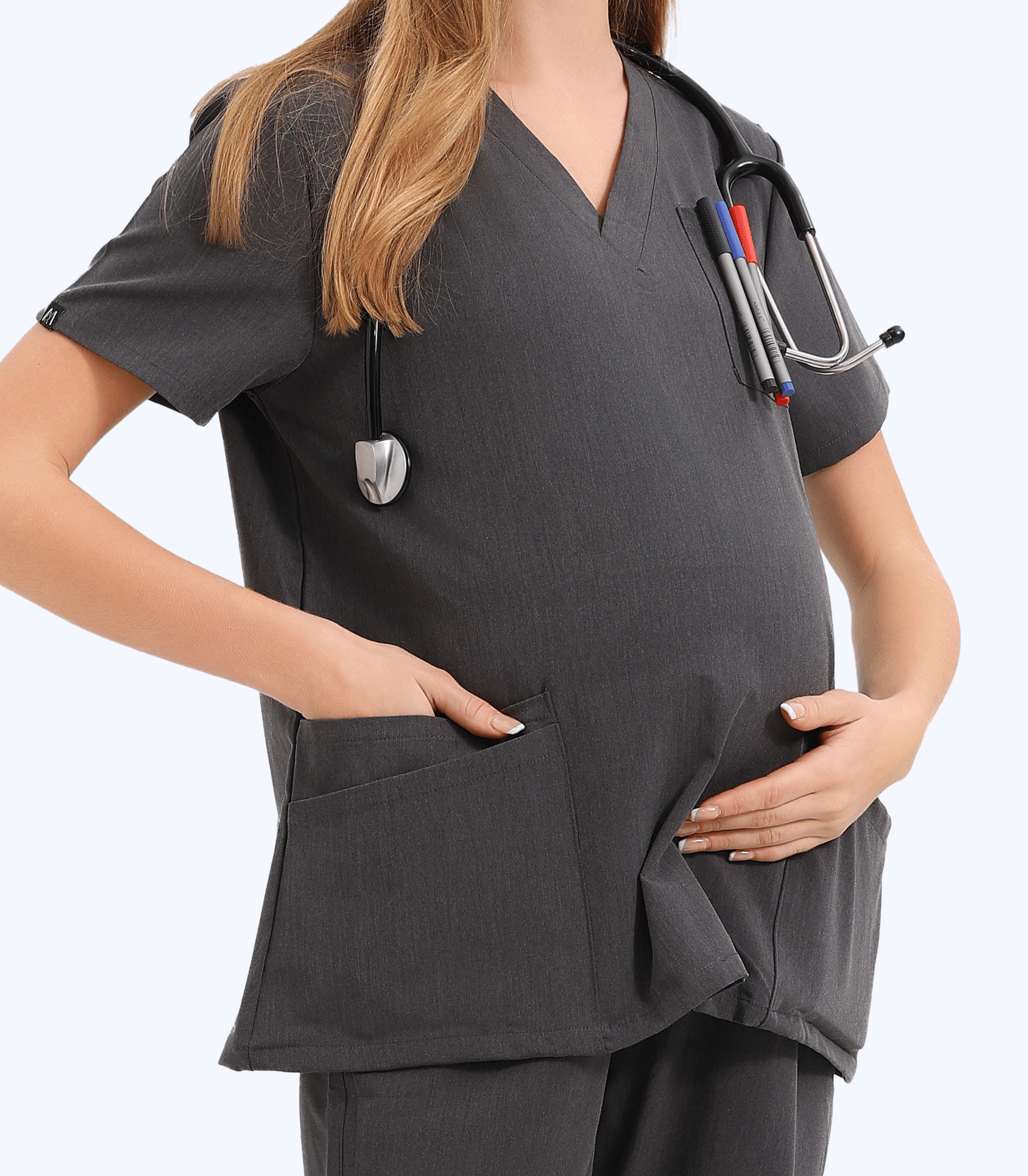 Pregnant medical professional wearing stylish Mae maternity scrub top from Maternity Scrubs Collection