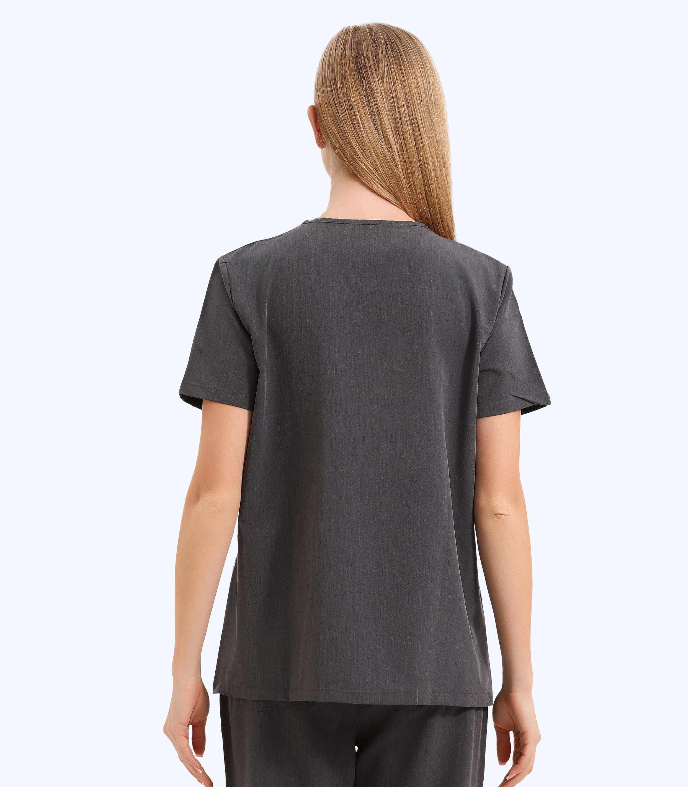 Pregnant medical professional wearing comfortable stylish maternity scrub top from Maternity Scrubs Collection