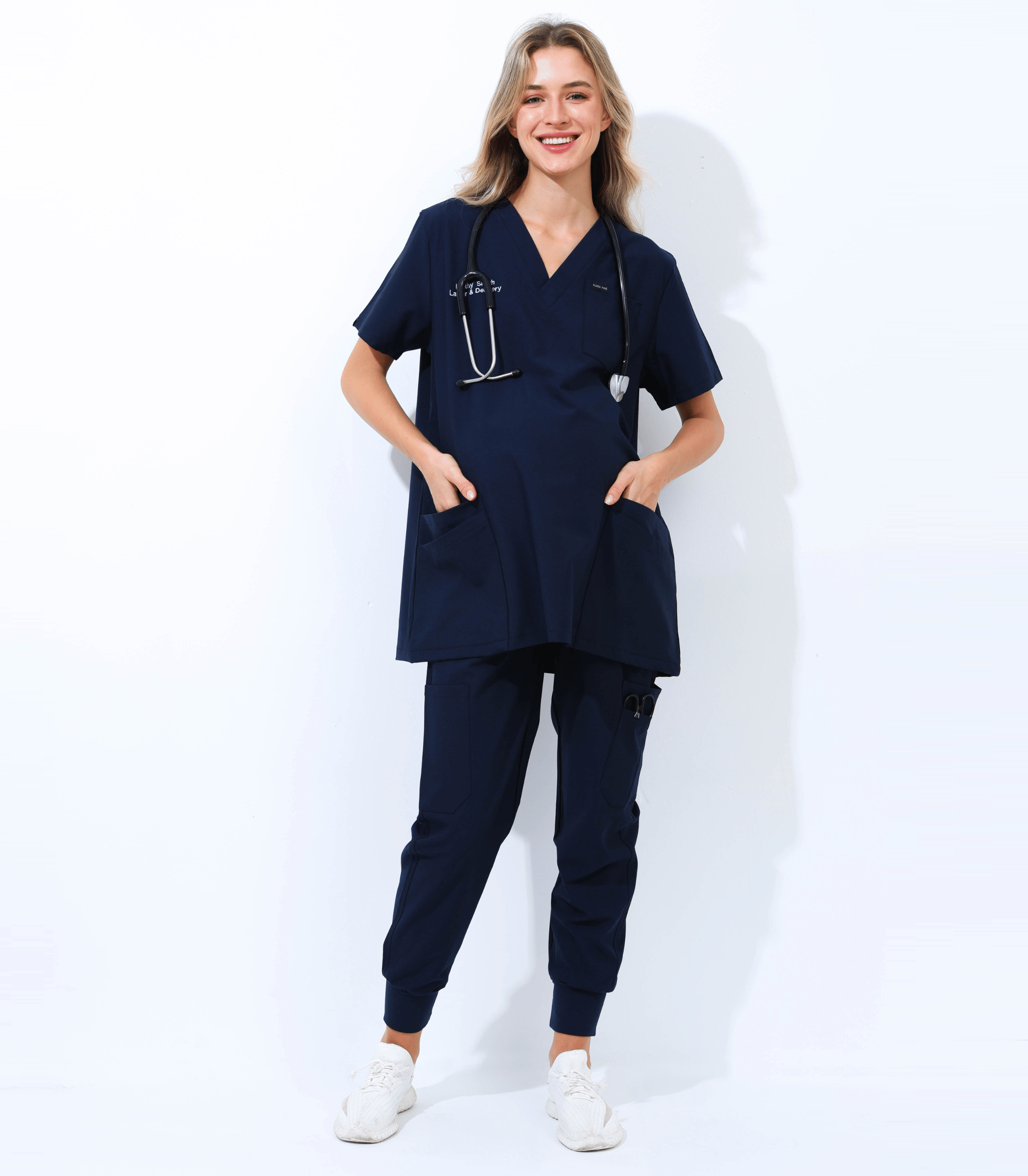 Pregnant medical professional wearing comfortable and stylish maternity scrubs from the Maternity Scrubs Collection