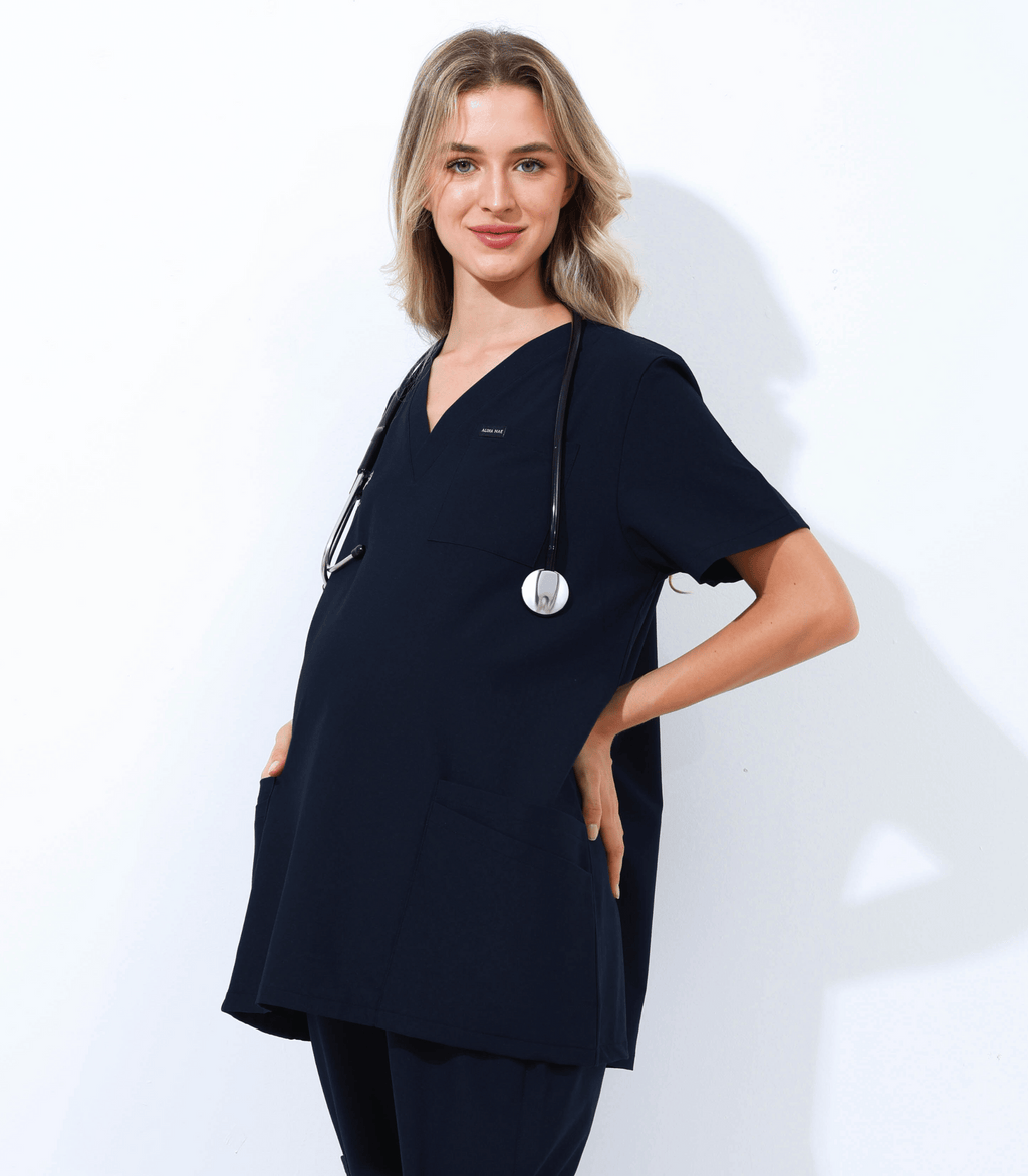 Pregnant medical professional wearing stylish and comfortable maternity scrubs from the Maternity Scrubs Collection in a clinical setting
