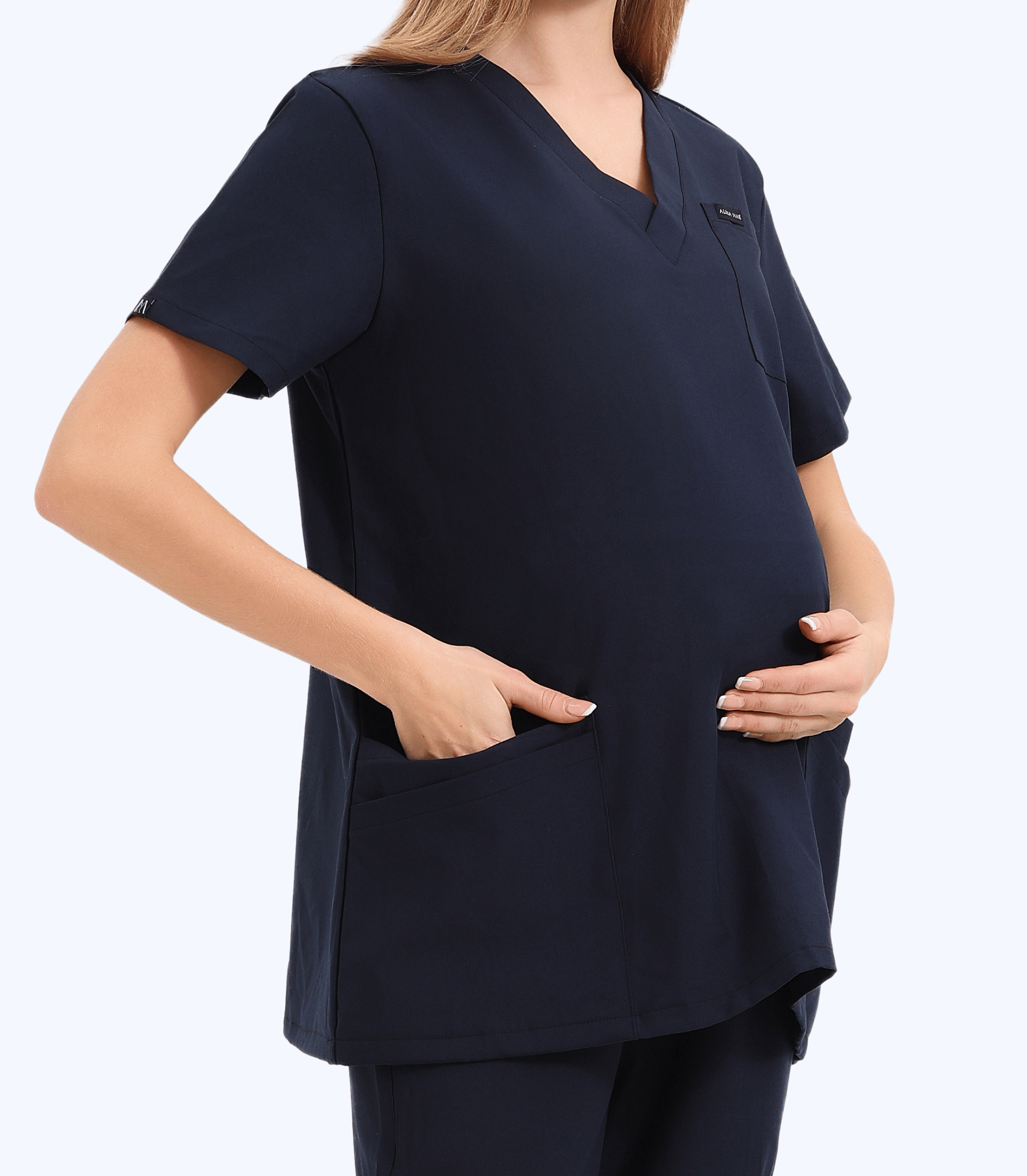 Pregnant medical professional wearing stylish and comfortable maternity scrubs from the Maternity Scrubs Collection designed for healthcare workers