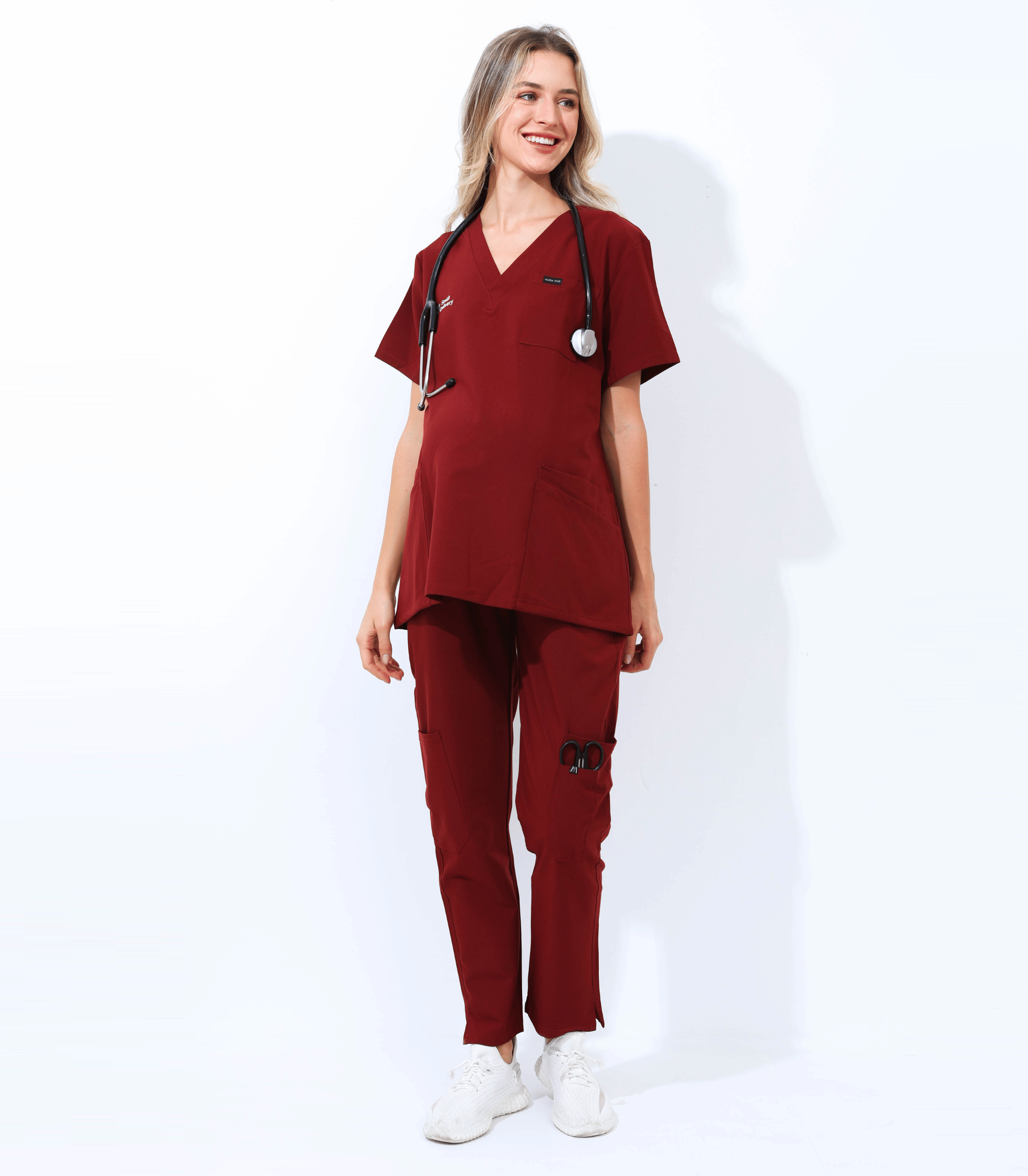 Pregnant medical professional wearing Mae maternity scrub top from Maternity Scrubs Collection, stylish and comfortable healthcare uniform