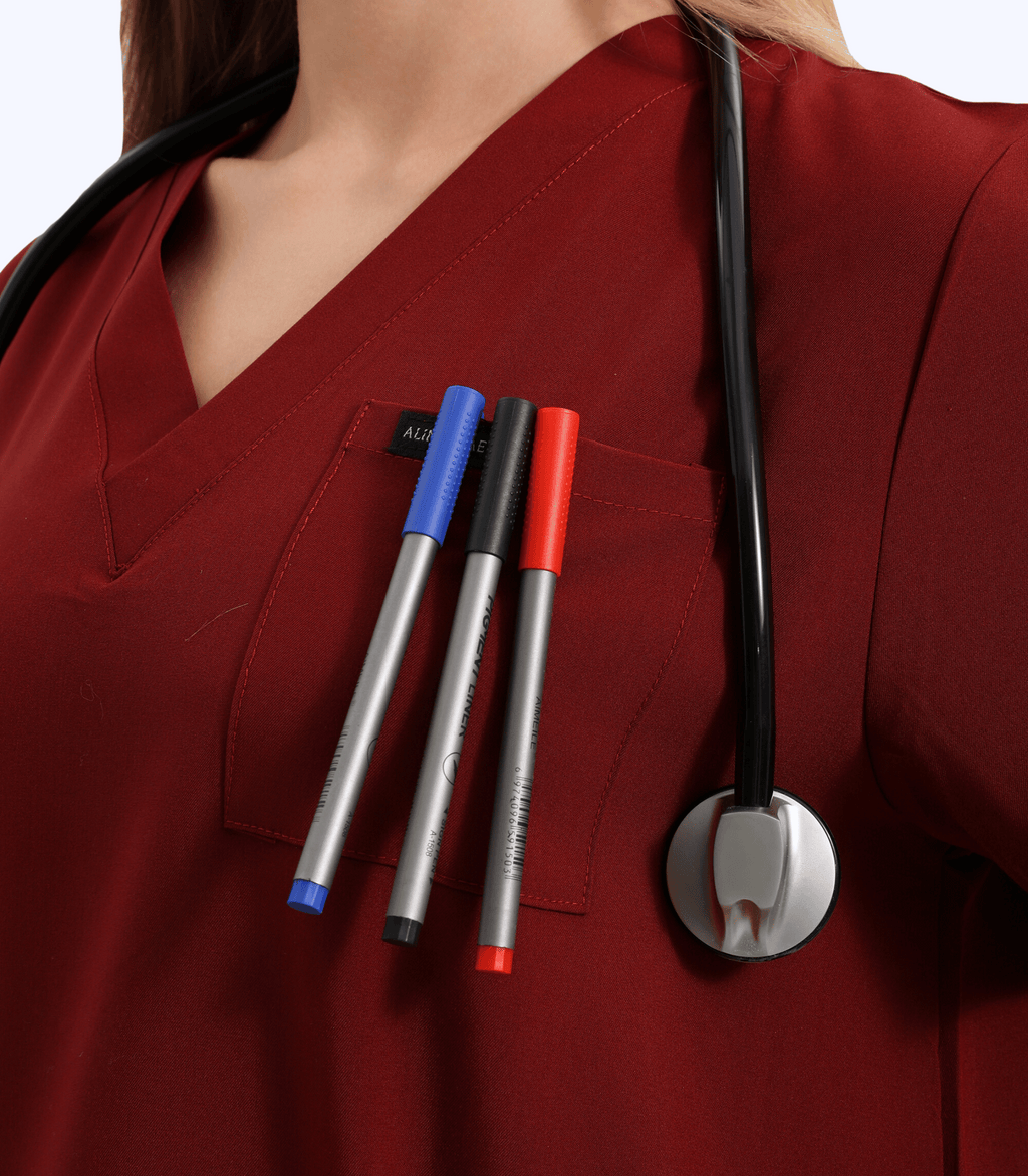 Pregnant medical professional wearing stylish and comfortable maternity scrubs top from Maternity Scrubs Collection