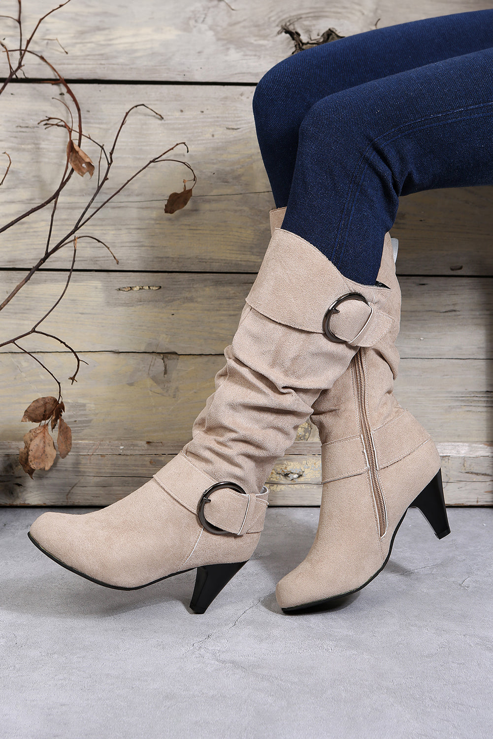 Navy blue mid-calf heeled boots with dual buckle straps and side zip closure