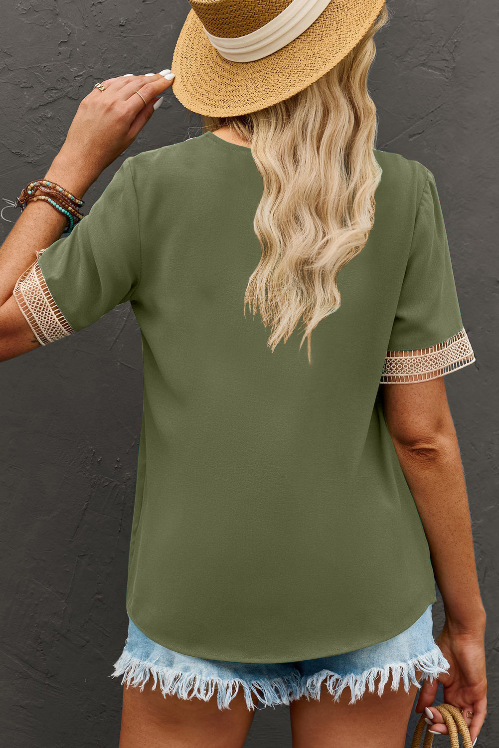 Green V neck blouse with short sleeves and lace trim detail