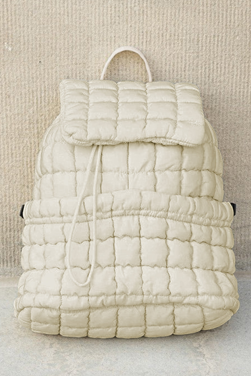 Black solid flapped quilted puffer backpack with spacious interior and textured stylish design
