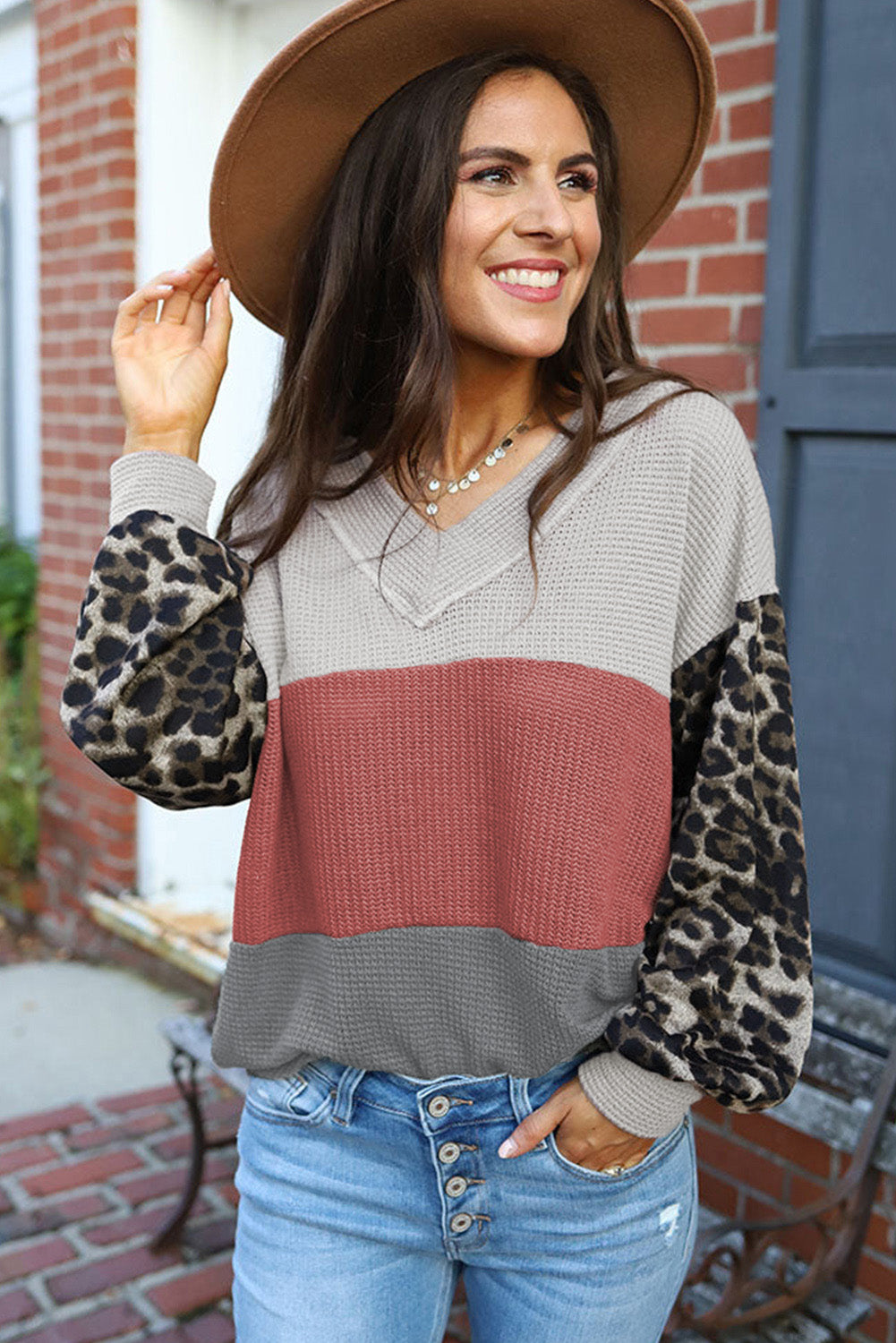 Fiery red waffle knit top with wild leopard contrast sleeves and V-neck design