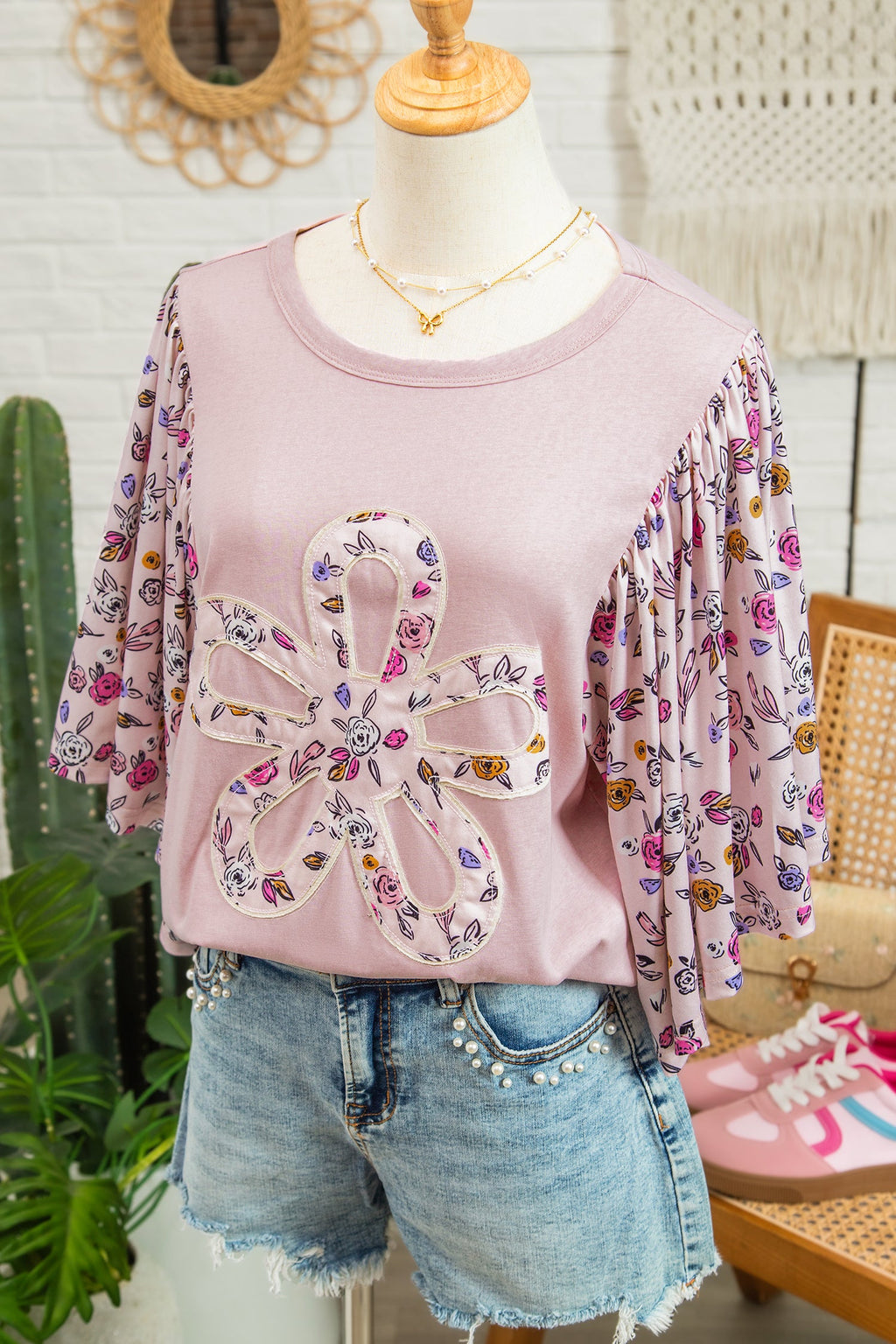 Pink blouse with floral patchwork and flowy half sleeves on solid pink base