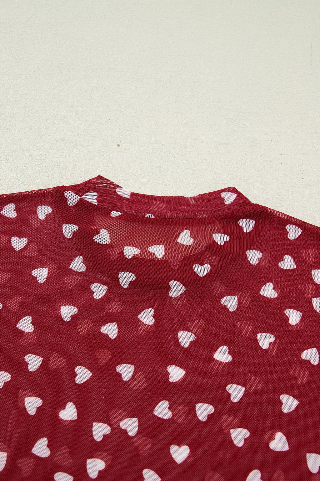 Pink sheer mesh crop top with allover heart print and lettuce trim