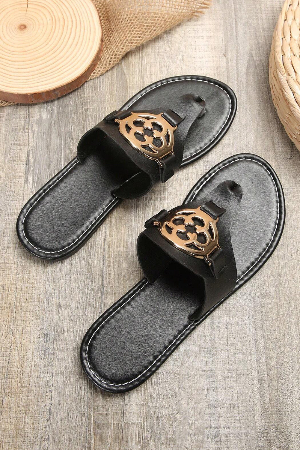 Beige leather thong slippers with stylish metal decor and adjustable straps