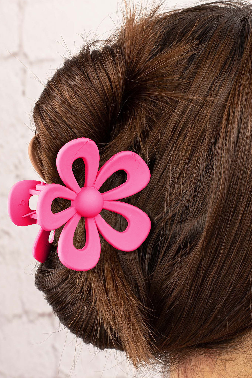 Black sweet hollowed flower shaped claw clip with frosting finish holding hair