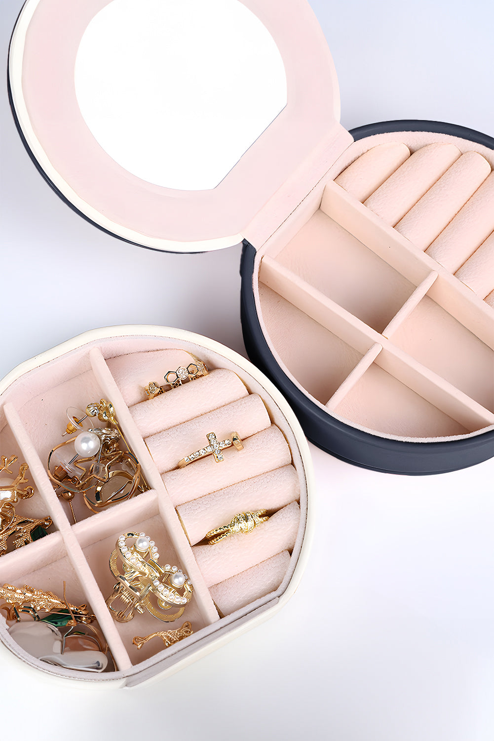 Light pink jewelry organizer case with snap closure and built-in mirror compact round shape