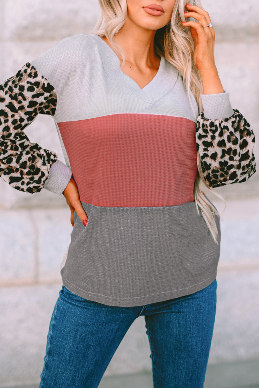 Fiery red waffle knit top with wild leopard contrast sleeves and V-neck collar