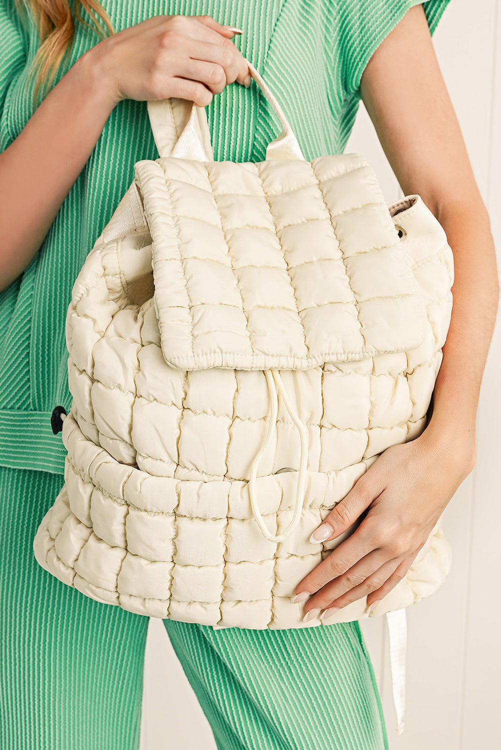 Black solid flapped quilted puffer backpack with spacious interior and modern design