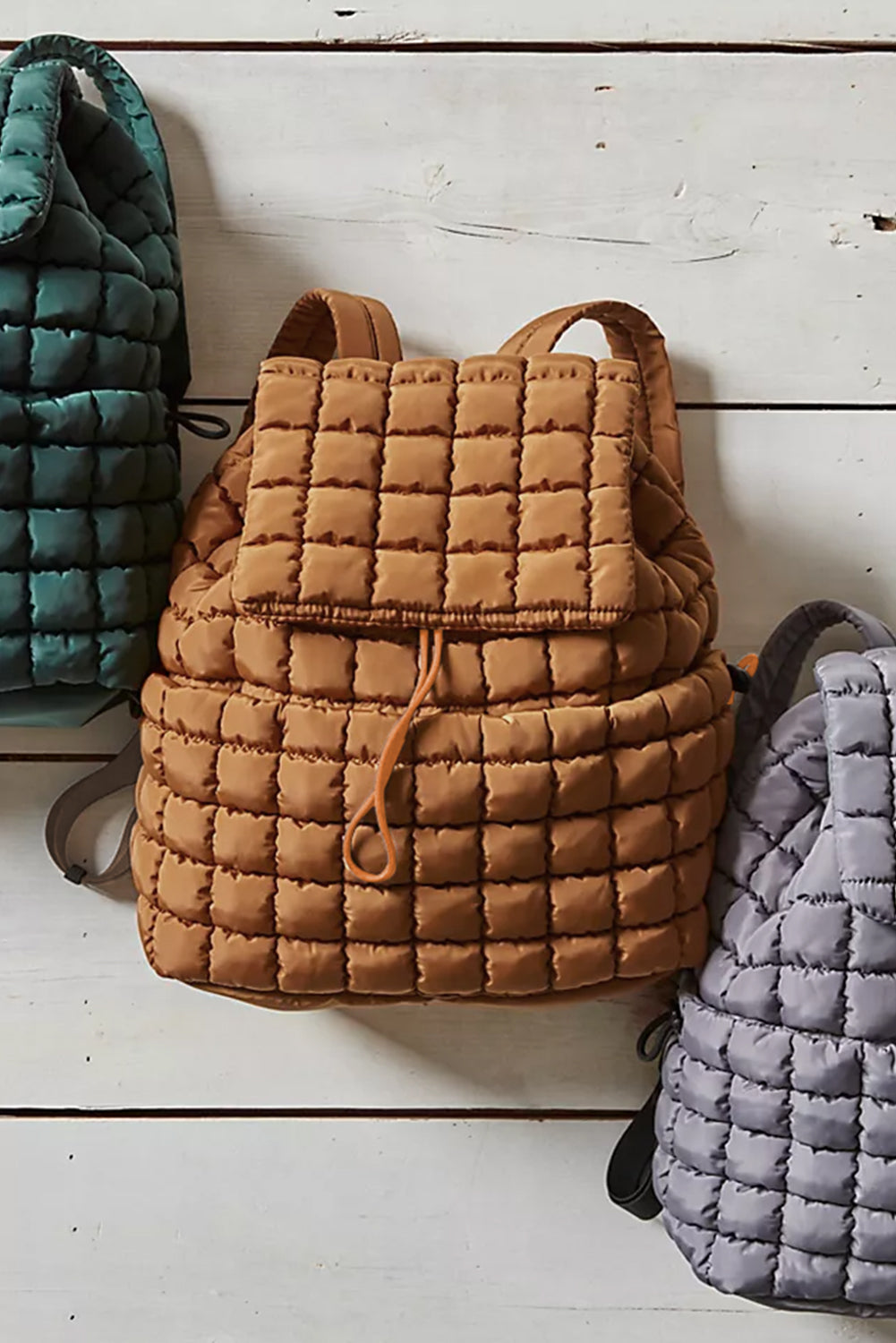 Black solid flapped quilted puffer backpack with spacious interior and modern design