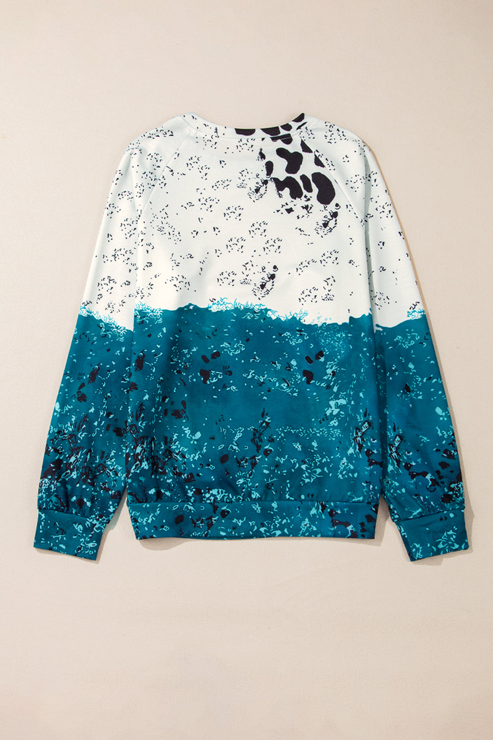 Blue tie dye cow color block pullover sweatshirt with raglan sleeves and vibrant print